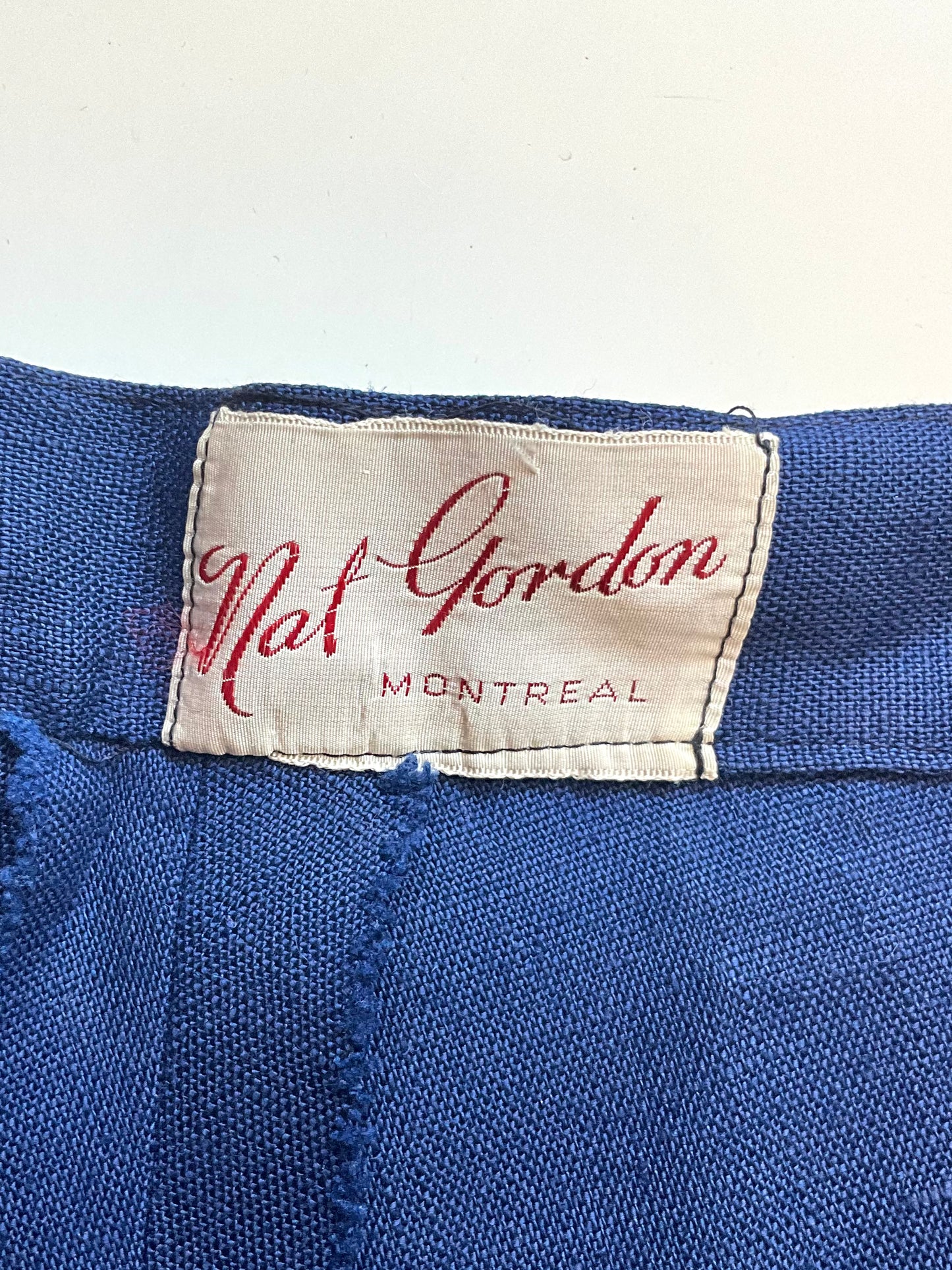 Close-up of a blue fabric with a Nat Gordon Montreal label.