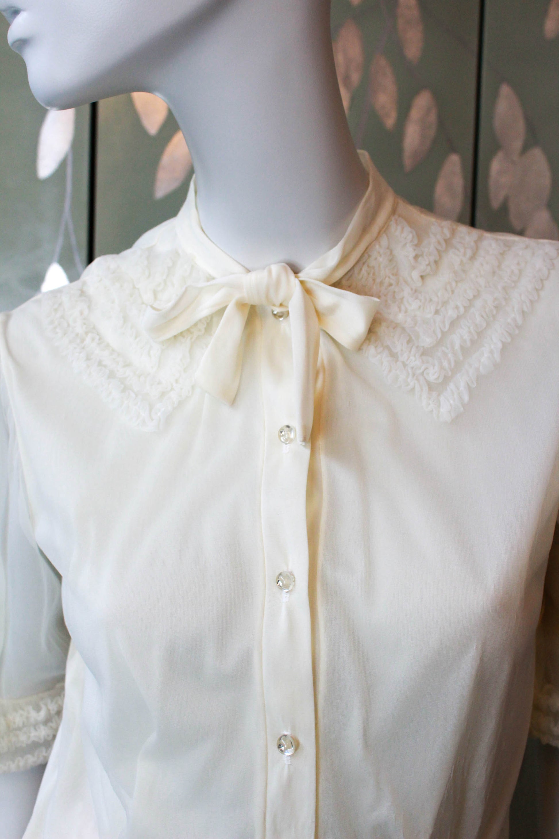 1950s nylon chiffon cream blouse with puff sleeves and faux ruffle appliqued collar design with tie neckline, sheer puff sleeves and clear rhinestone buttons vintage coquette aesthetic romantic feminine blouse