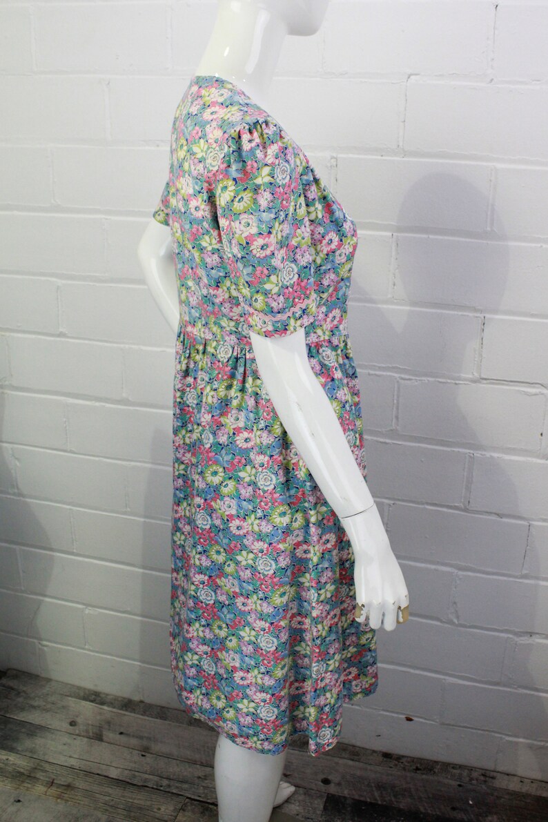 1950s floral print cotton dress with puff sleeves and plastic pink flower buttons, gathered skirt