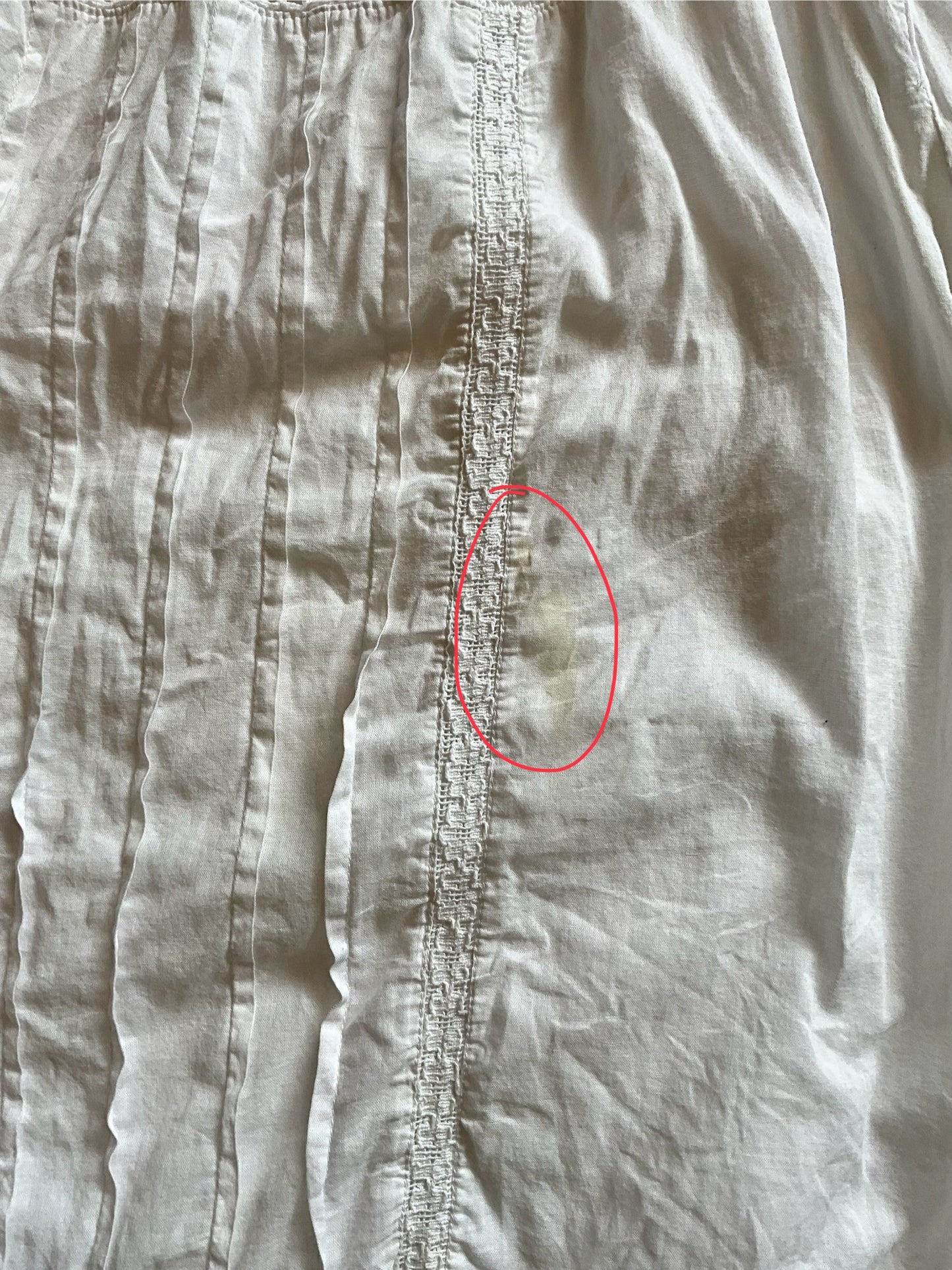 Close-up of a fabric with a red circle highlighting a small defect.