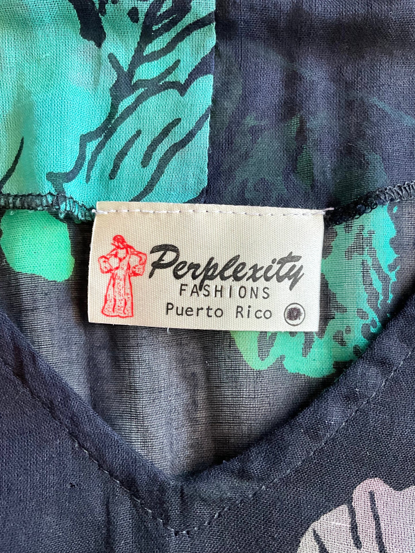 Perplexity Fashions label on a garment with green and black pattern