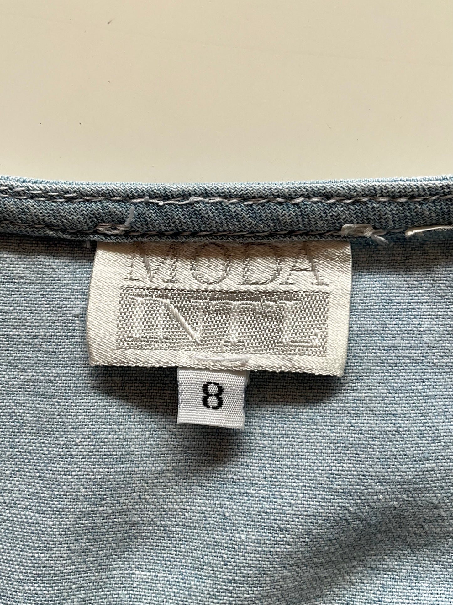 Label on a dress with 'MODA INT'L' branding and size '8'.