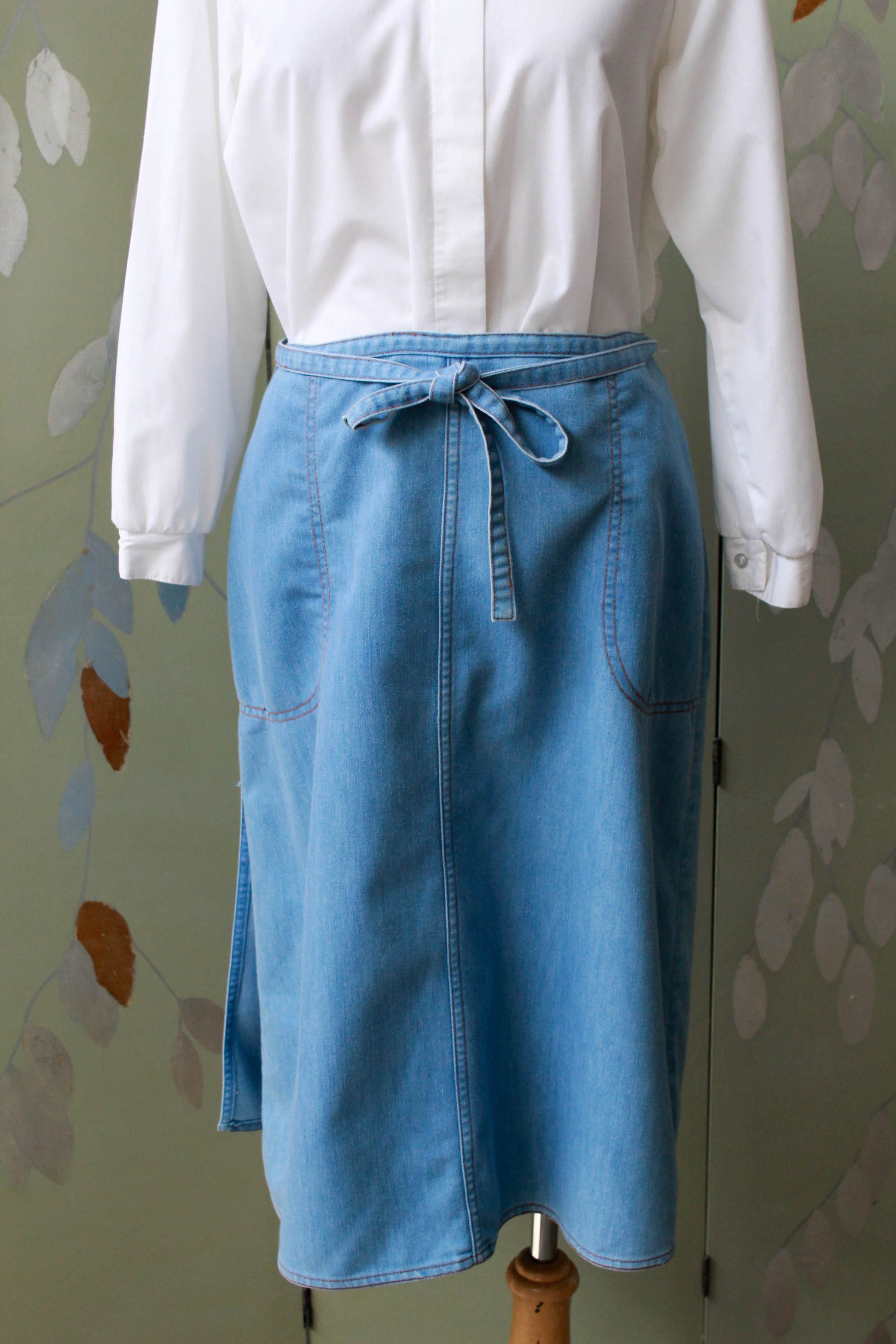 90s vintage chambray light blue jean wrap skirt with waist tie, side pockets, a-line silhouette