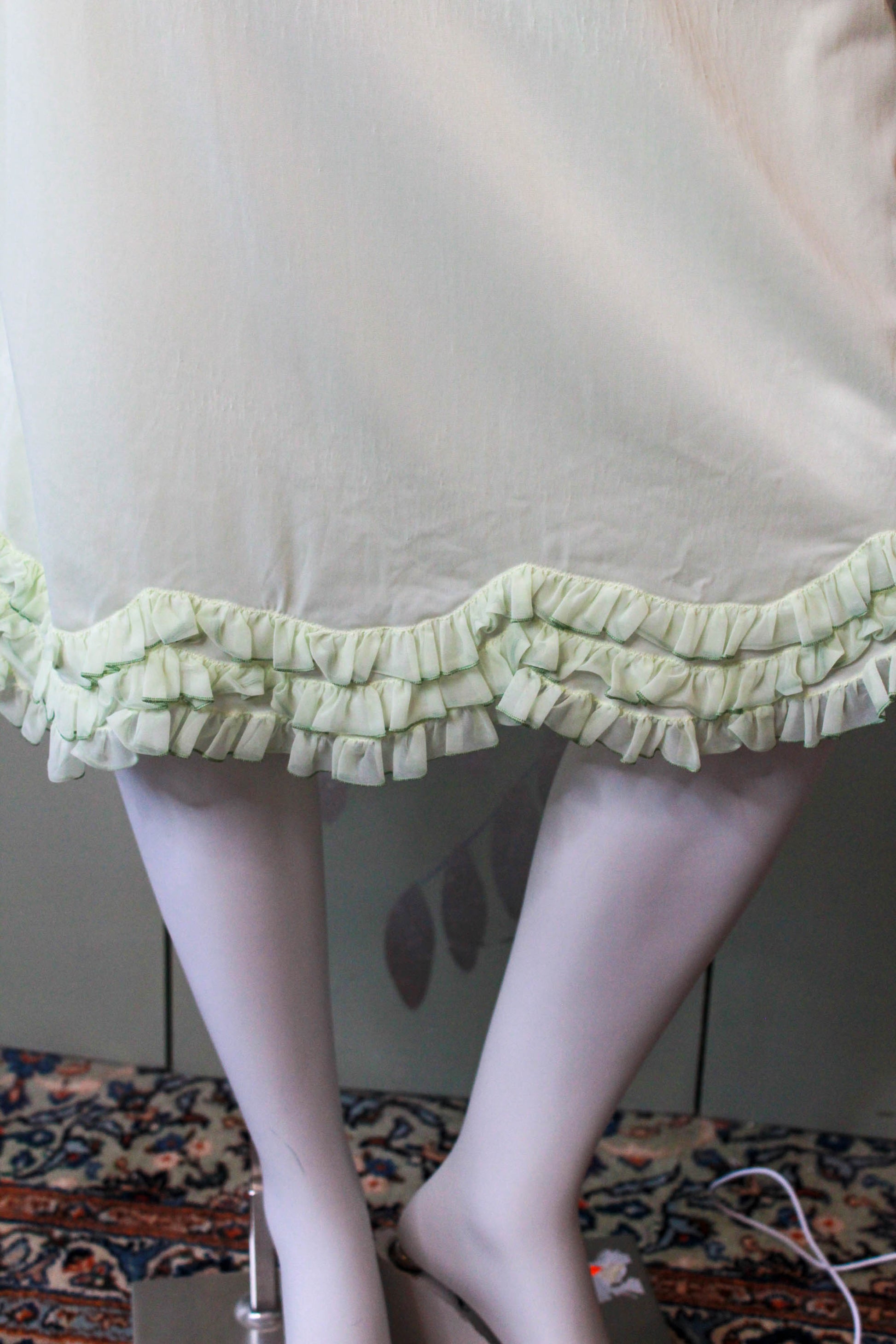1960s pale green nylon slip skirt with curved tiered ruffle hem