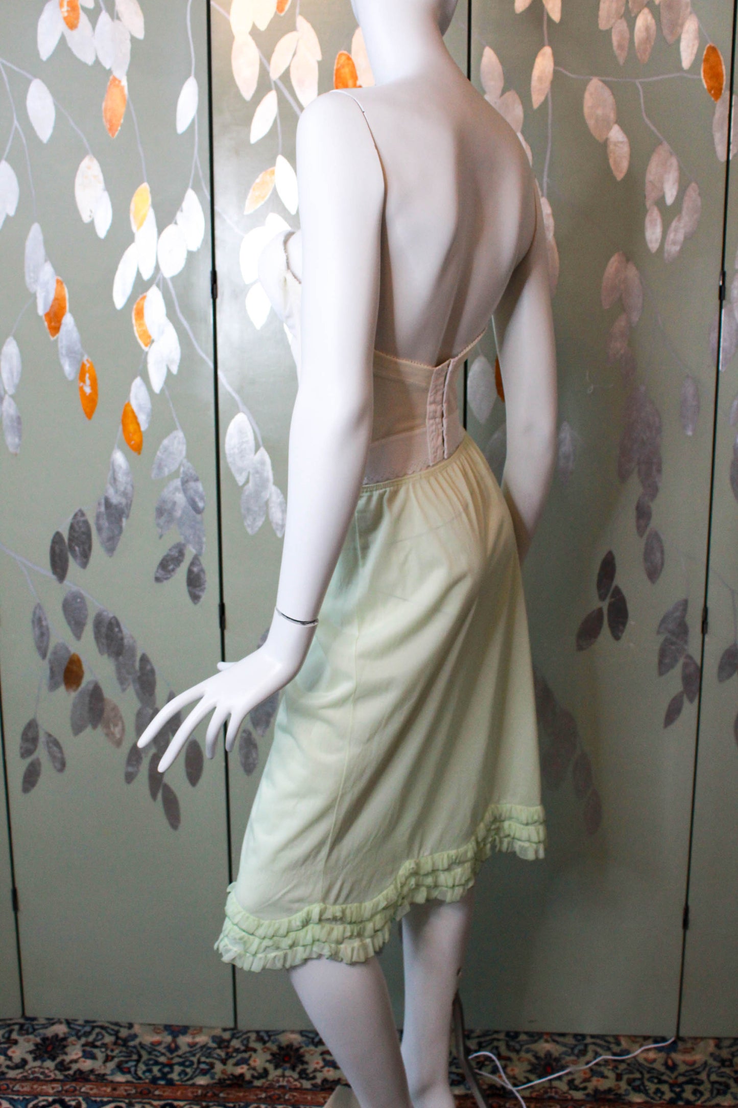 1960s pale green nylon slip skirt with curved tiered ruffle hem