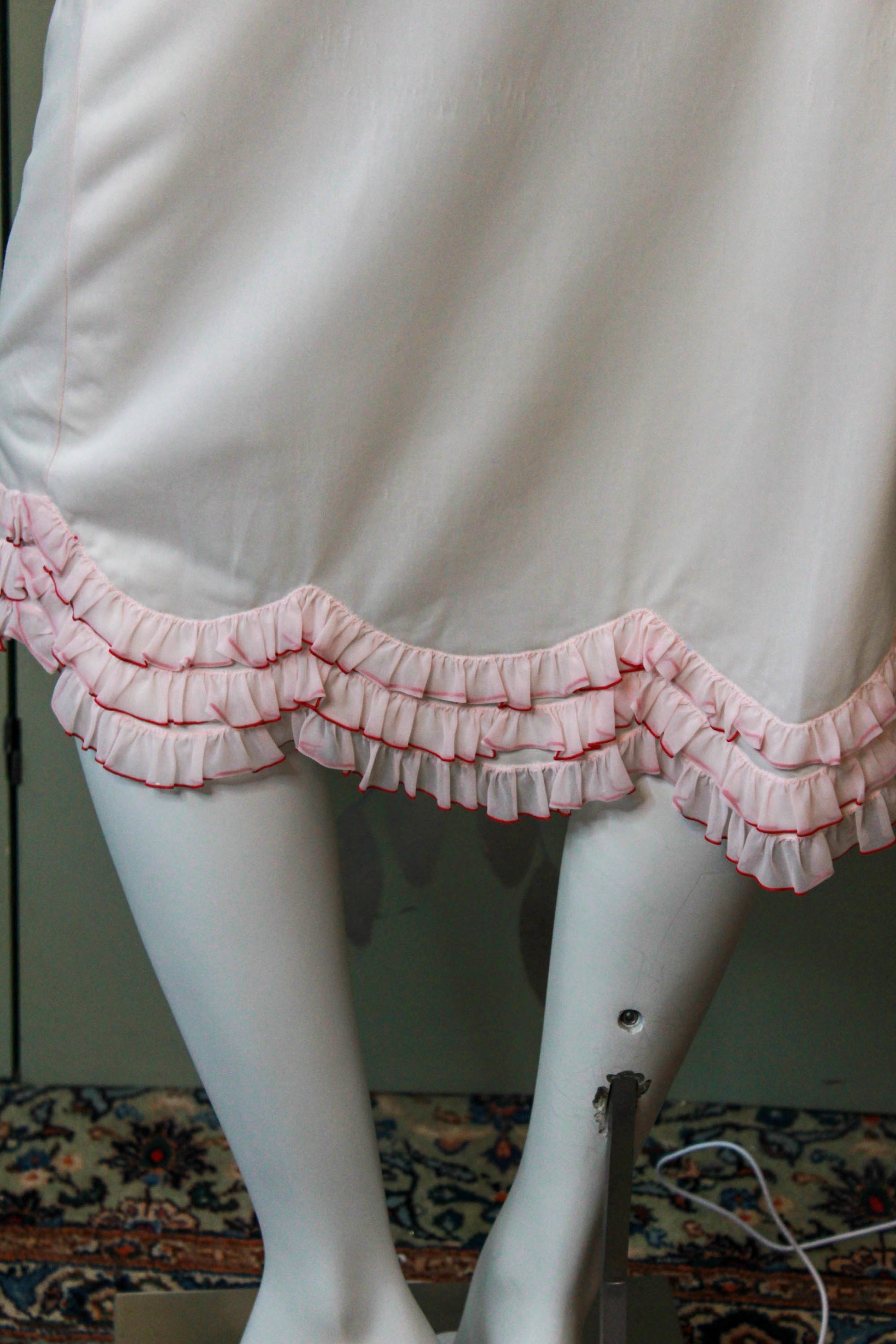 1960s pale pink nylon slip skirt with curved tiered ruffle hem coquette style