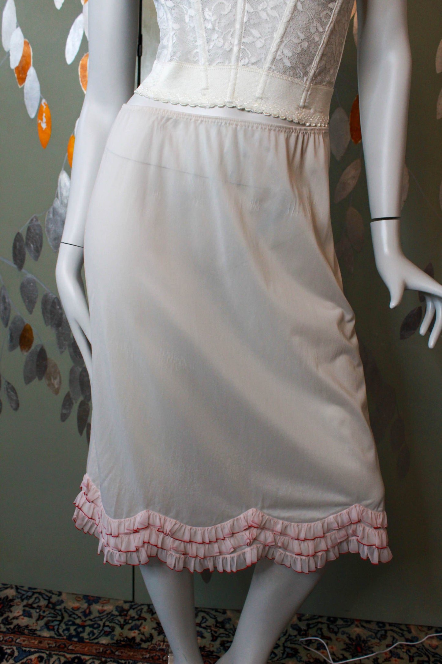 1960s pale pink nylon slip skirt with curved tiered ruffle hem coquette style