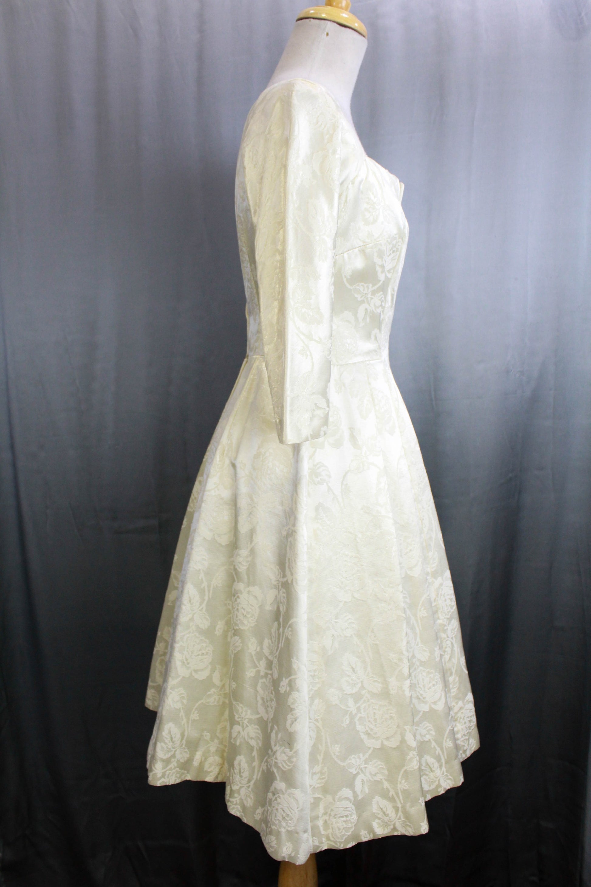 1950s bridal dress, white brocade satin with 3/4 sleeves and fit and flare silhouette
