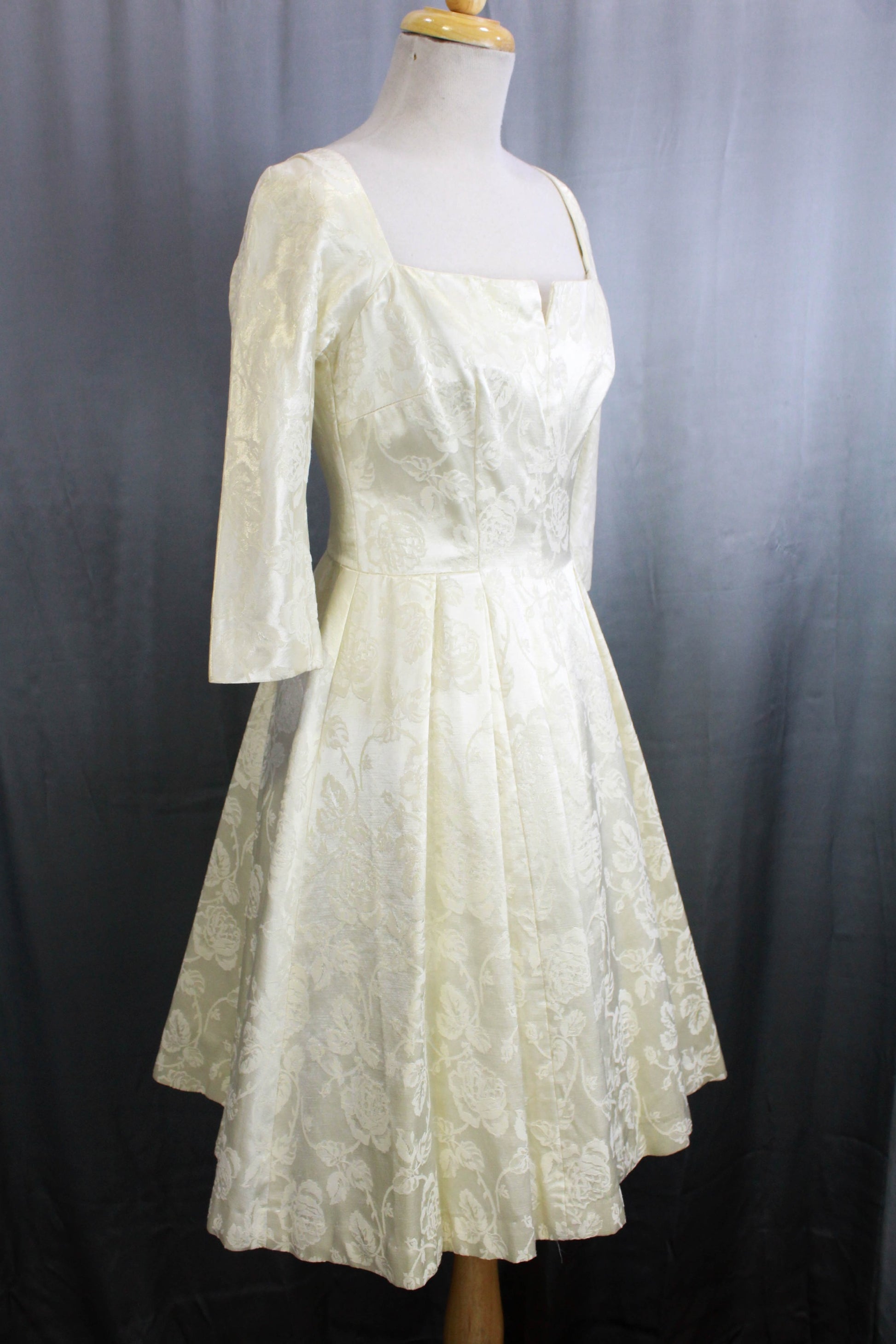 1950s bridal dress, white brocade satin with 3/4 sleeves and fit and flare silhouette