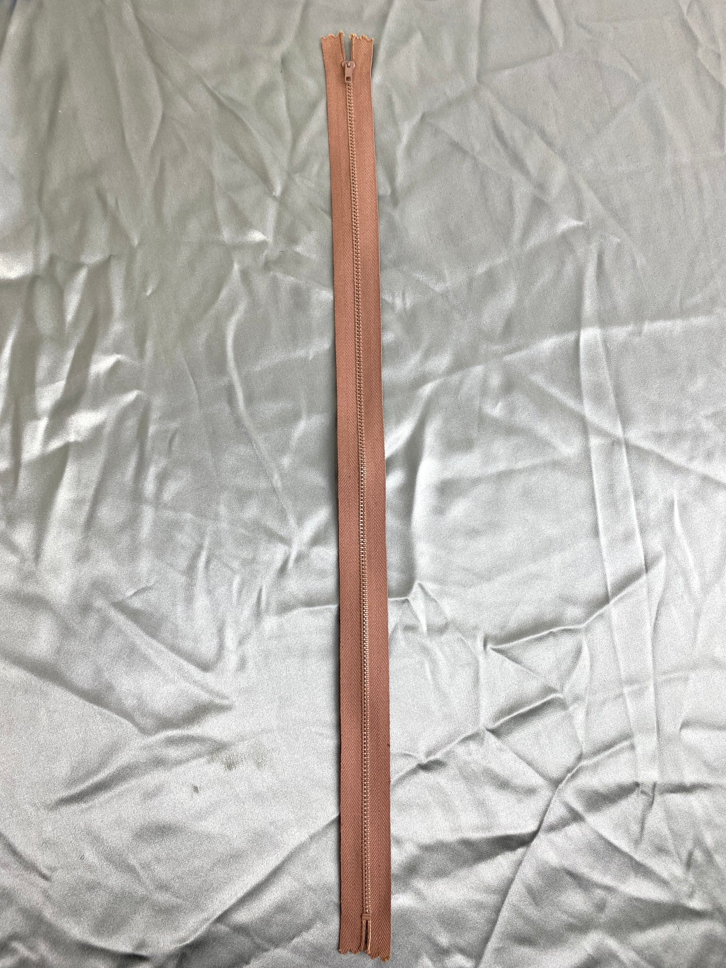 A single brown metal zipper. Ian Drummond Vintage.