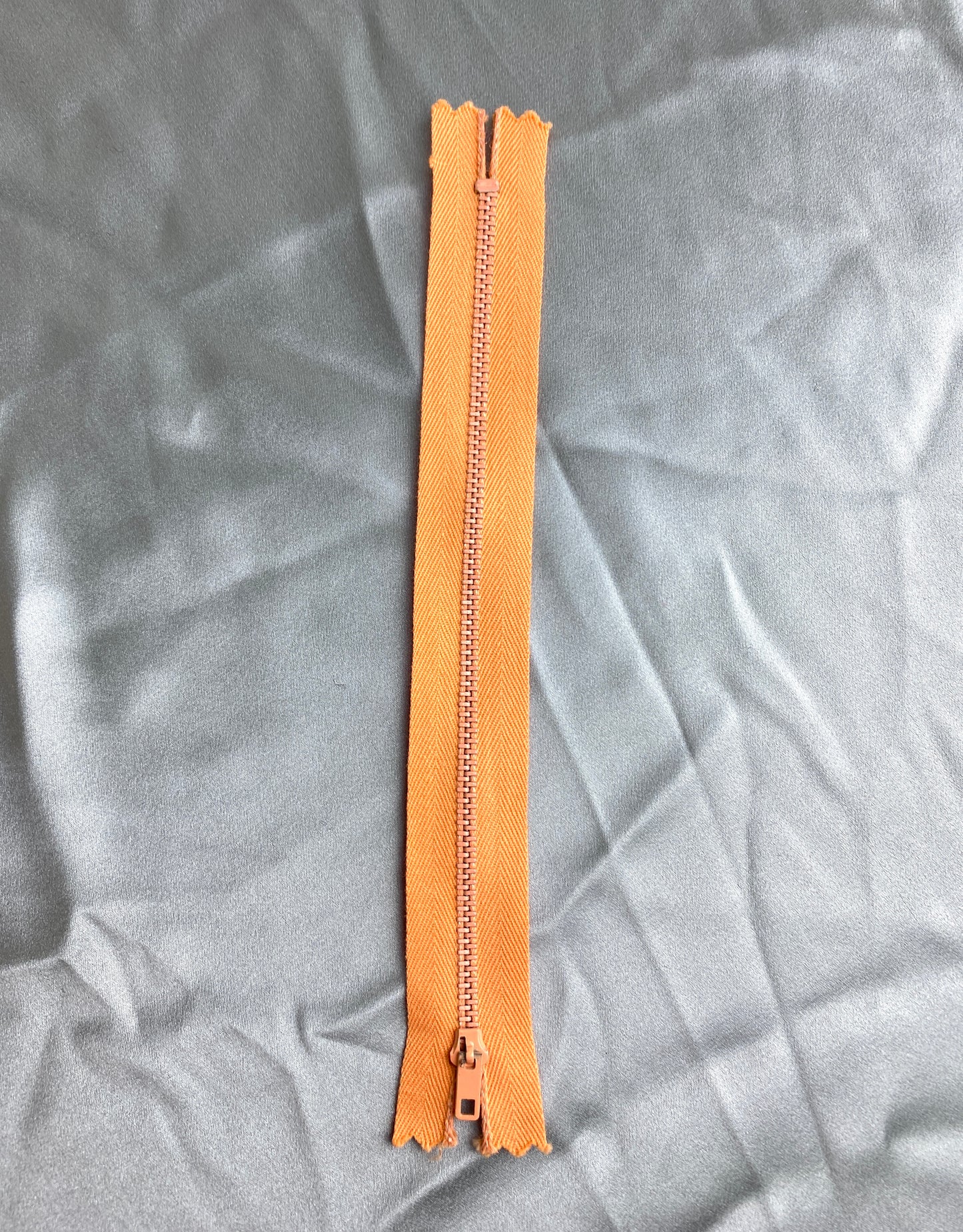 A single metal zipper. Vintage light orange colour. Ian Drummond Vintage.