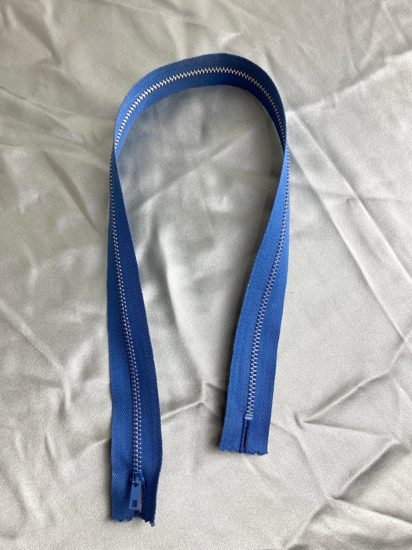 A single dark blue vintage metal zipper. Ian Drummond Vintage.