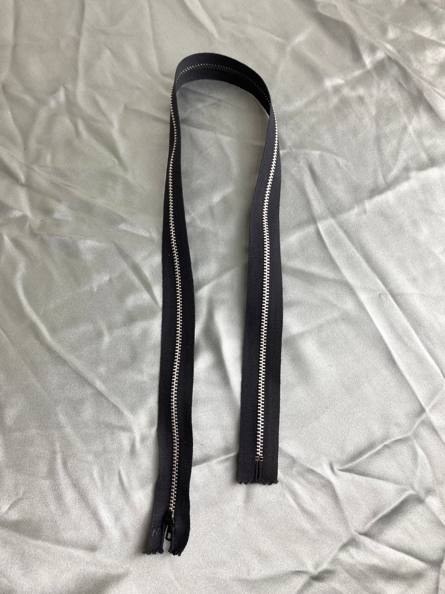 A single black metal zipper. Ian Drummond Vintage.