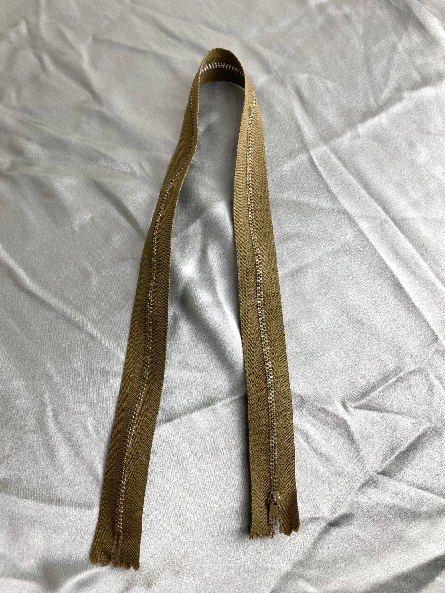 A single moss green vintage metal zipper. Ian Drummond Vintage.