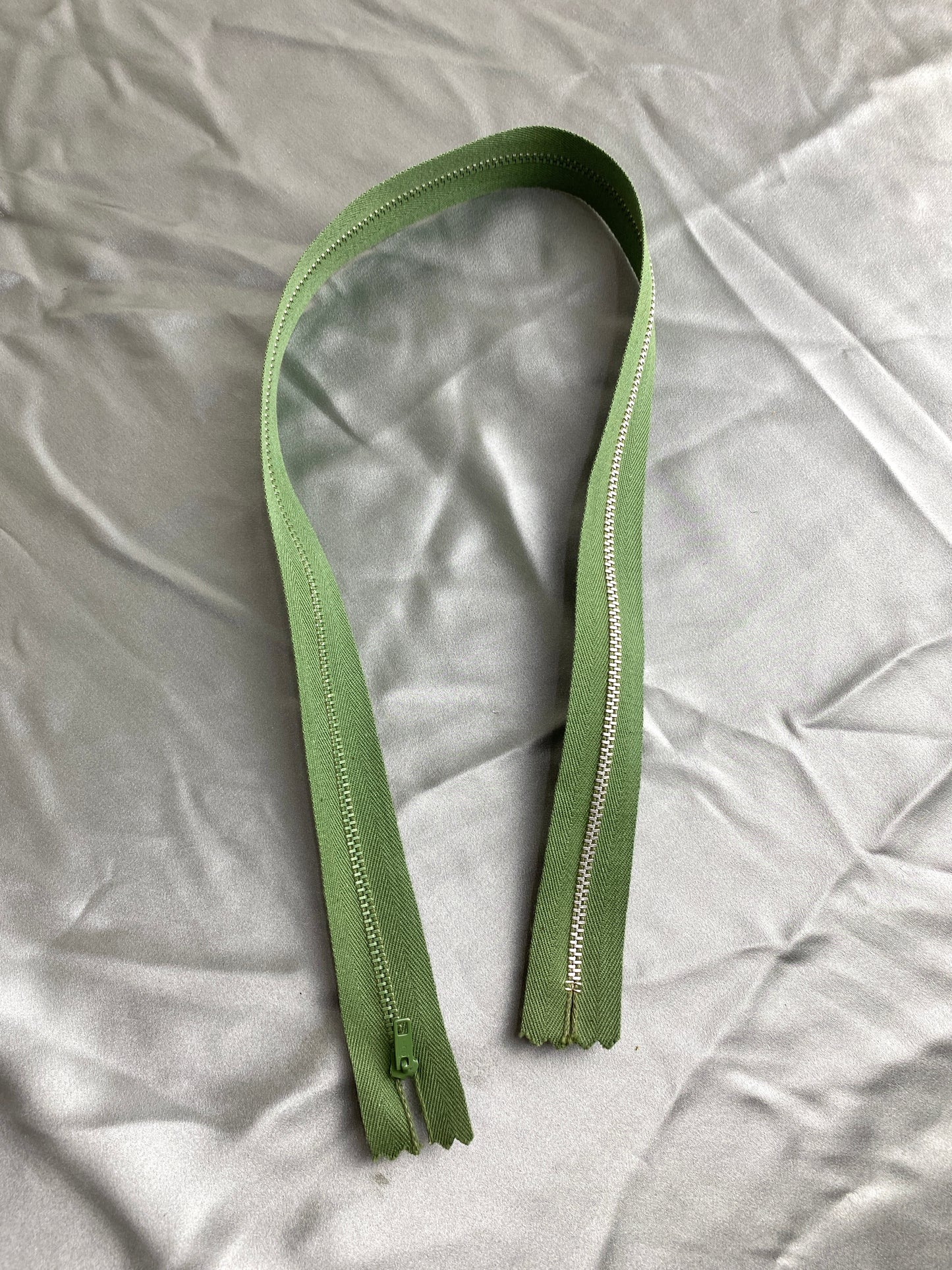 A single hunter green metal zipper. Ian Drummond Vintage.