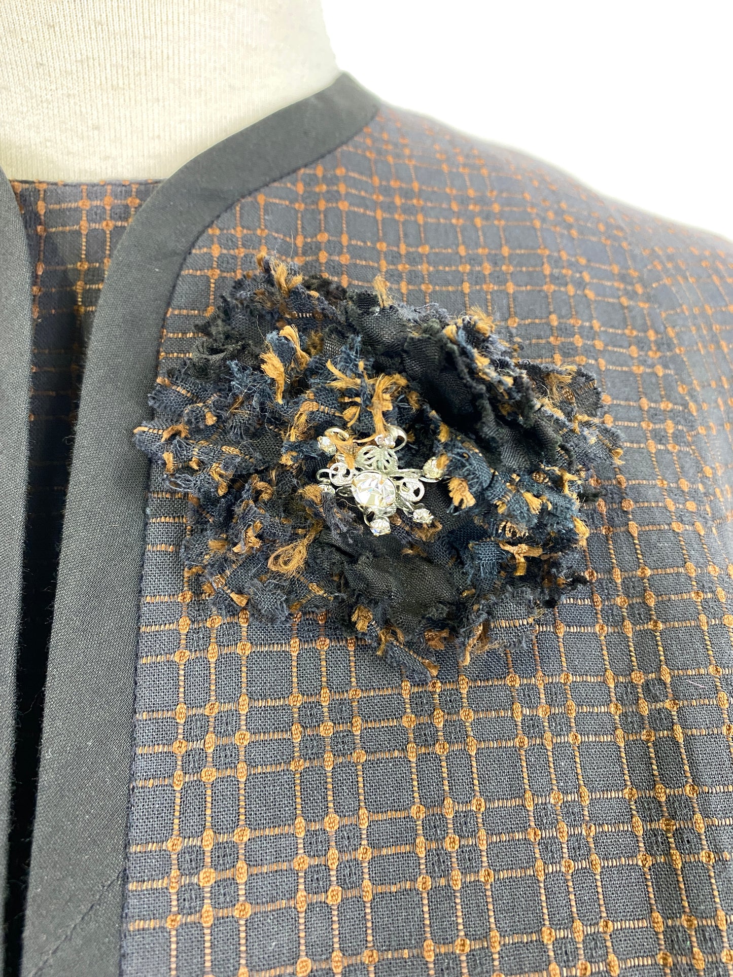 Close-up of fabric brooch on 1960s bolero jacket. Ian Drummond Vintage. 