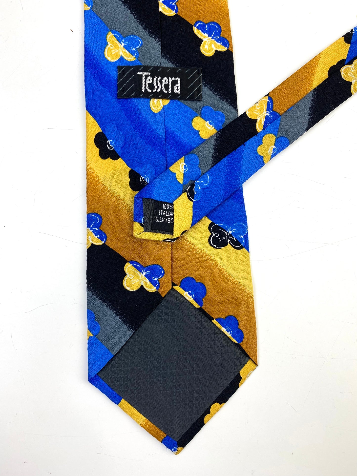 Back and labels of: 90s Deadstock Silk Necktie, Men's Vintage Gold/Blue/Black Diagonal Stripe Floral Butterfly Pattern Tie, NOS