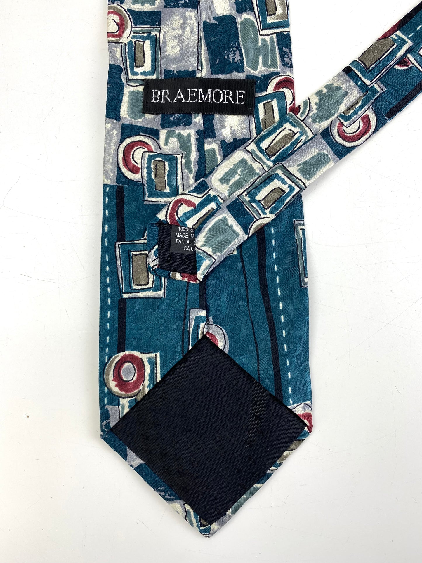 Back and labels of: 90s Deadstock Silk Necktie, Men's Vintage Teal/ Wine Geometric Pattern Tie, NOS