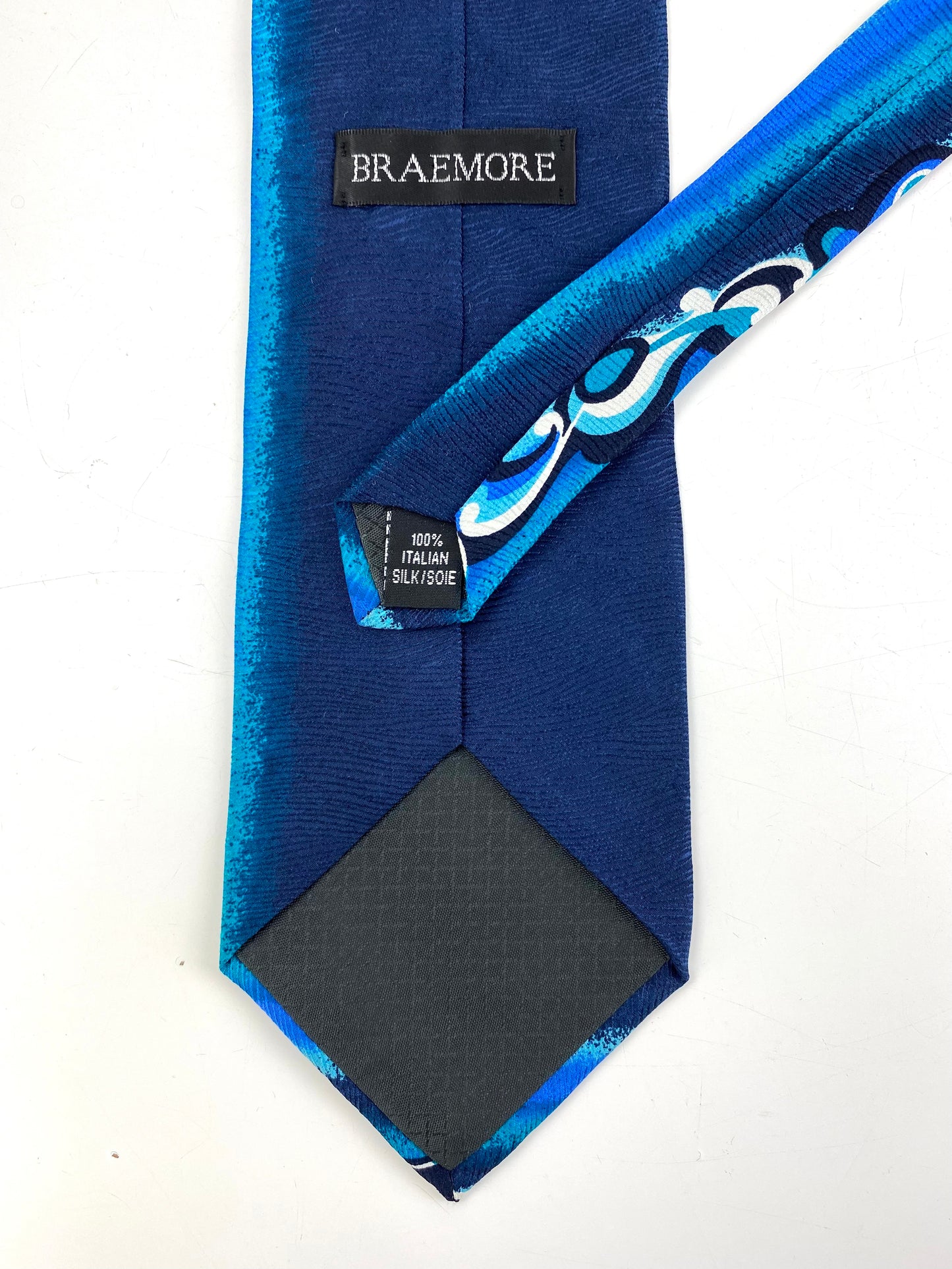 Back and labels of: 90s Deadstock Silk Necktie, Men's Vintage Teal Blue Abstract Wave Pattern Tie, NOS