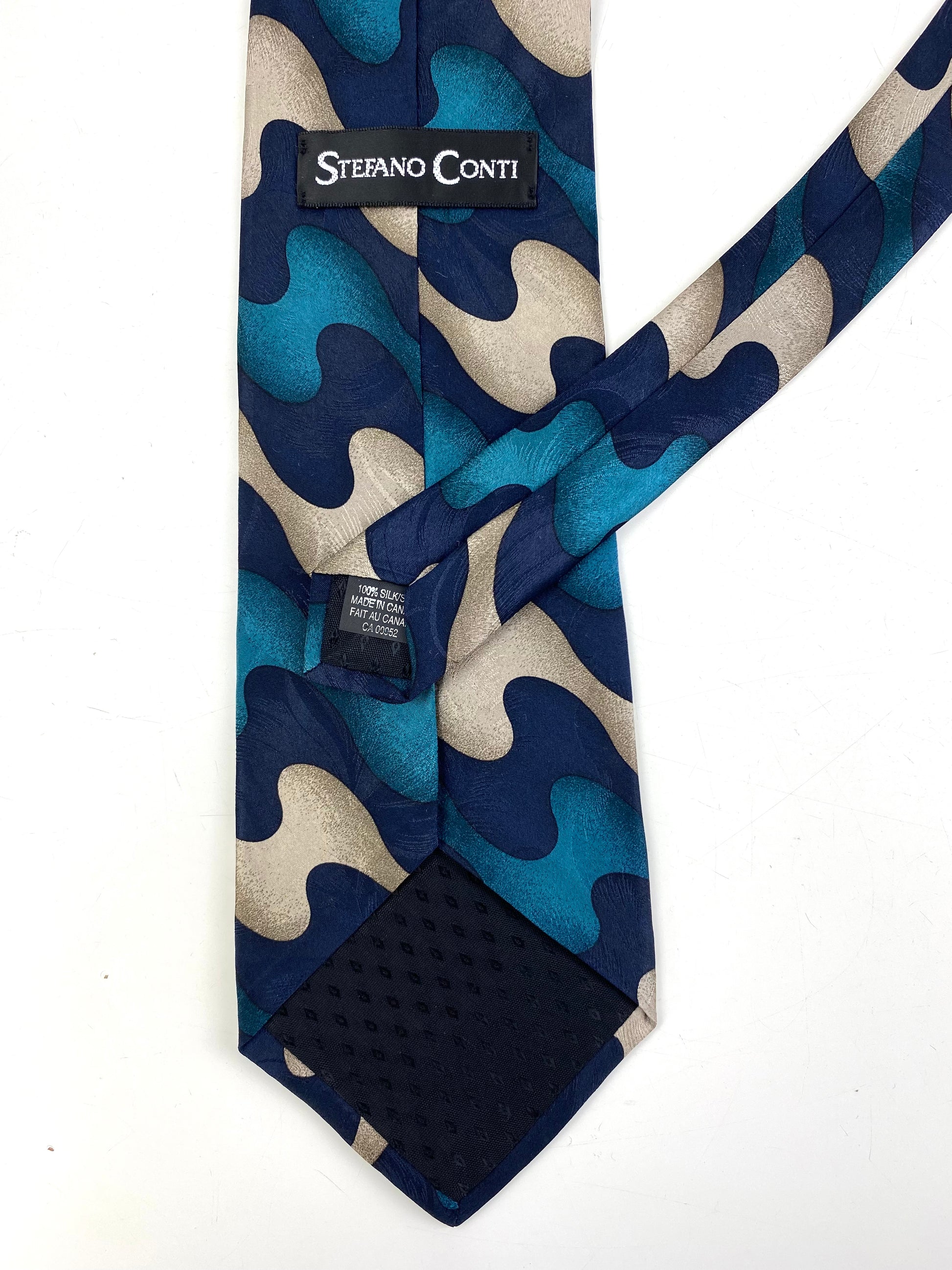 Back and labels of: 90s Deadstock Silk Necktie, Men's Vintage Teal/ Navy/ Beige Abstract Pattern Tie, NOS