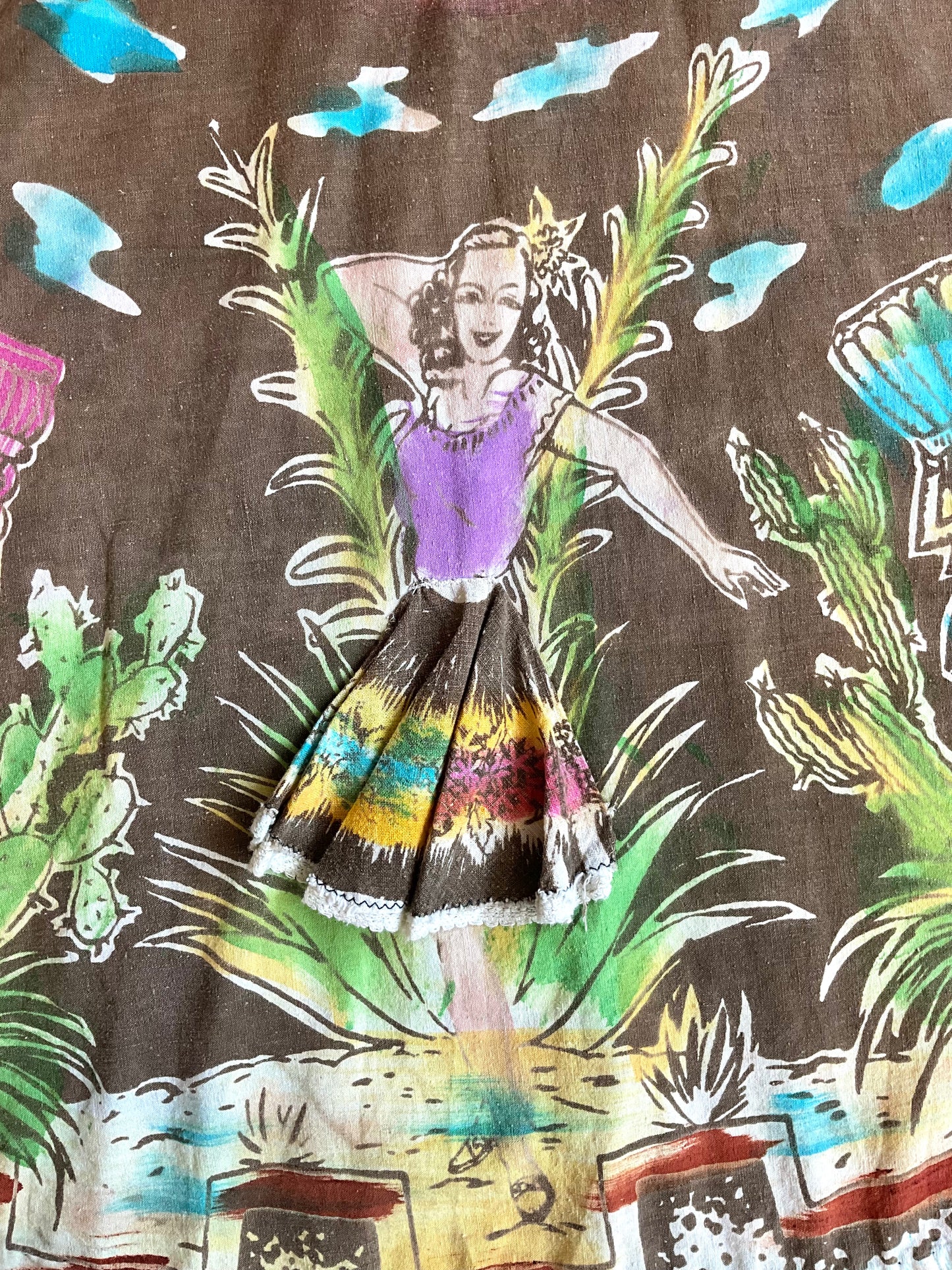 Fabric with a colorful design of a woman and nature elements on a brown background
