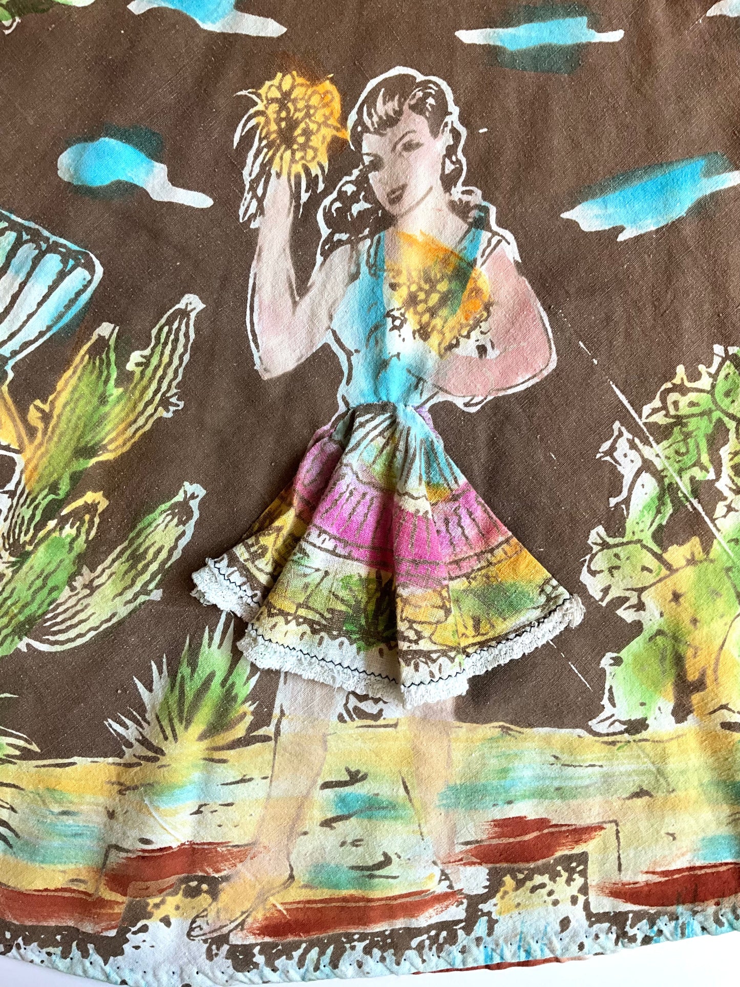 Fabric with a colorful illustration of a woman and cacti on a brown background