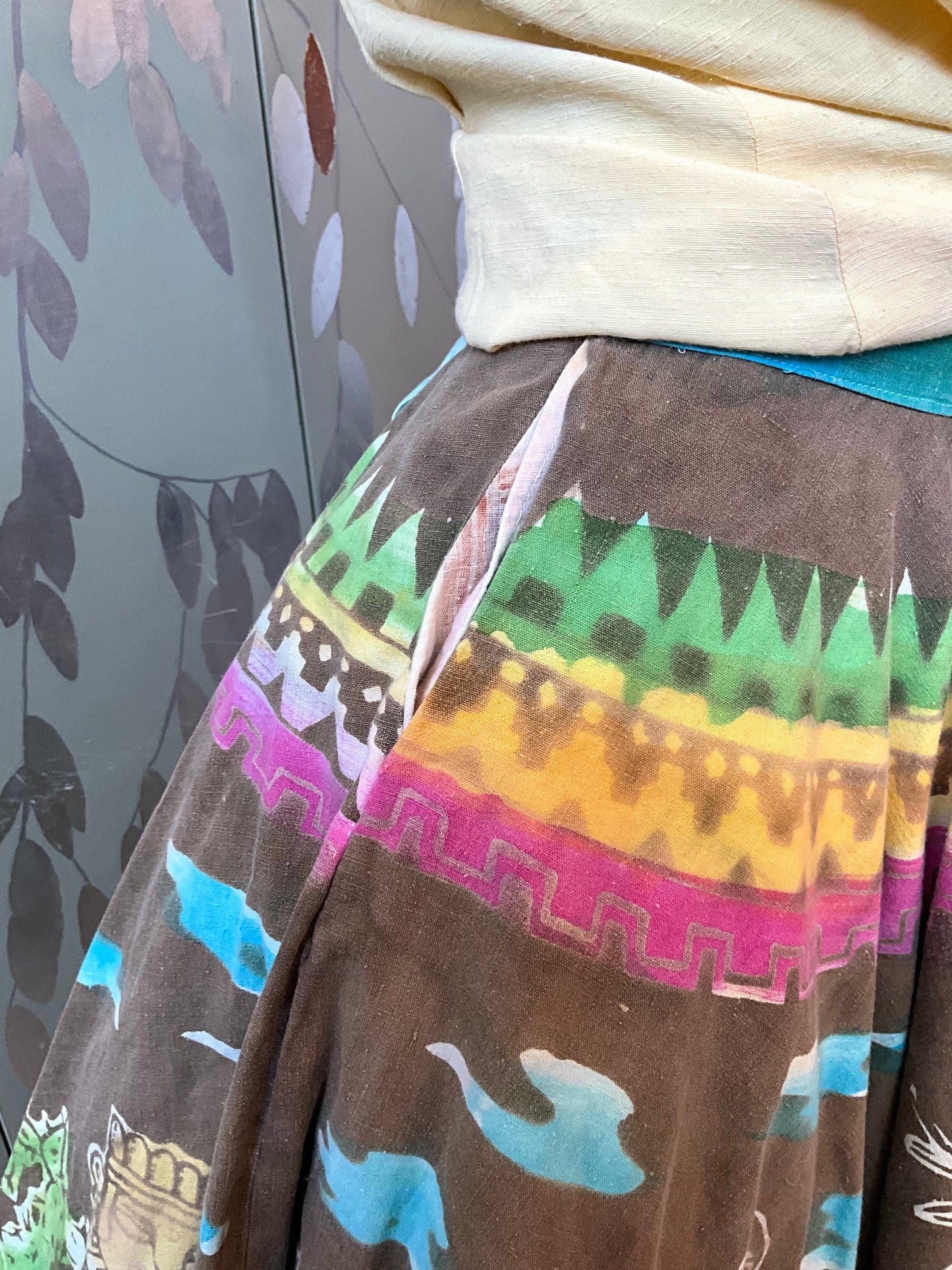 Colorful patterned fabric with geometric designs on a neutral background