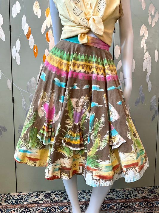 Mannequin wearing a colorful skirt with a pattern of people in a vintage setting against a floral-patterned wall.