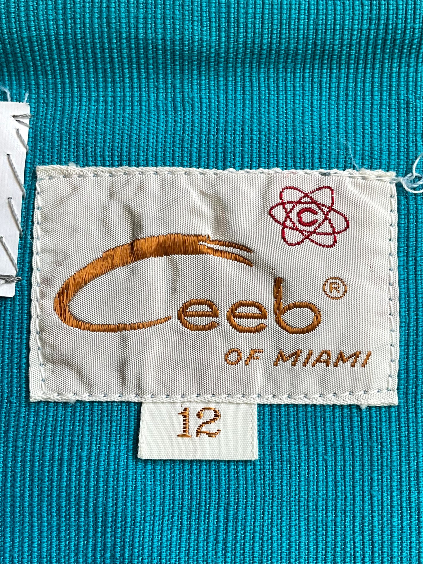 Ceeb of Miami label on a blue textured fabric background