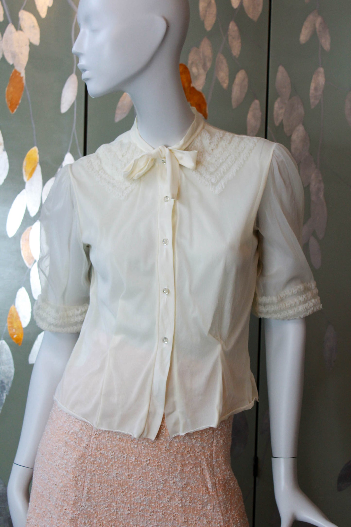 1950s nylon chiffon cream blouse with puff sleeves and faux ruffle appliqued collar design with tie neckline, sheer puff sleeves and clear rhinestone buttons vintage coquette aesthetic romantic feminine blouse