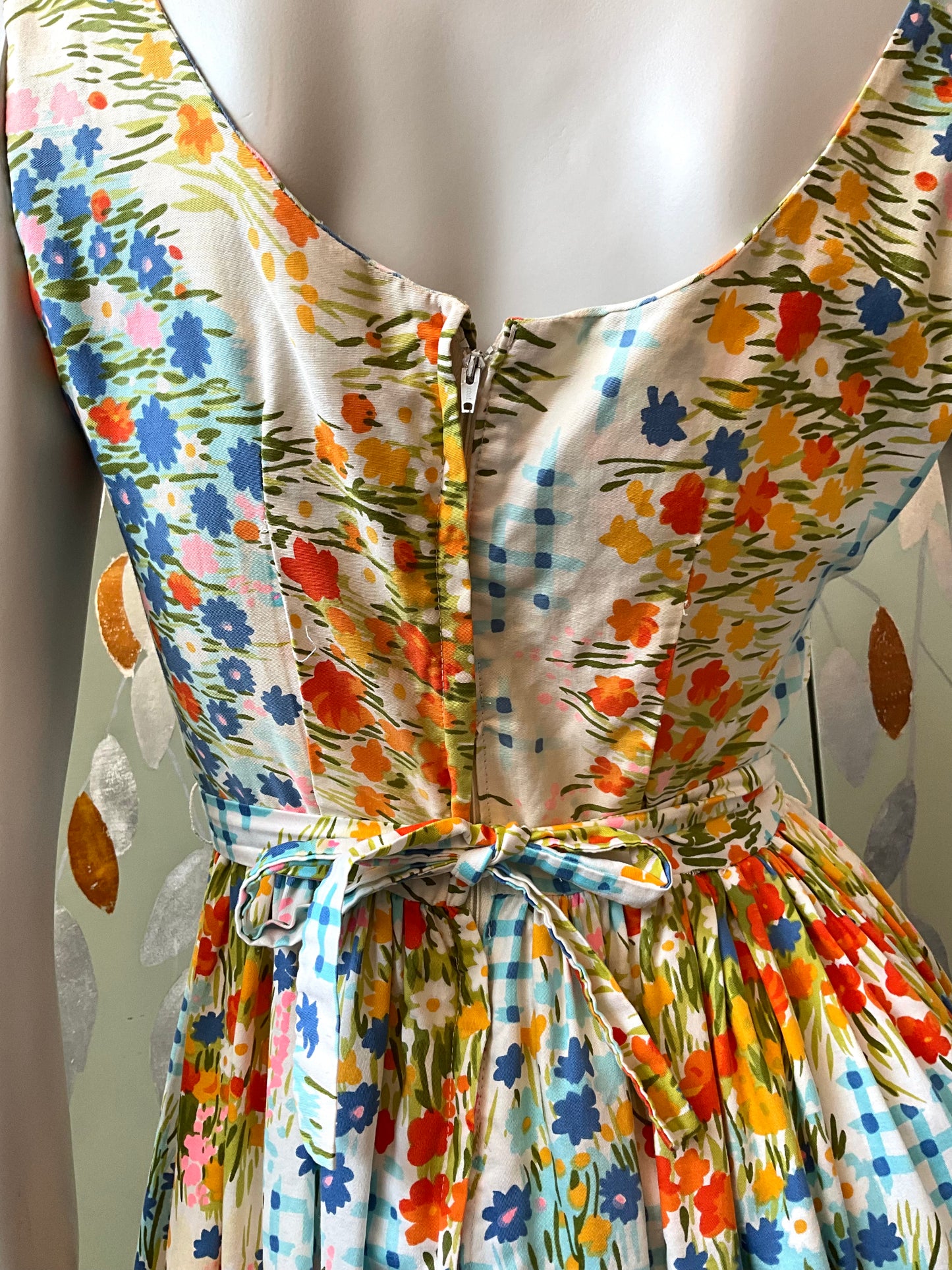 Mannequin wearing a colorful floral dress 