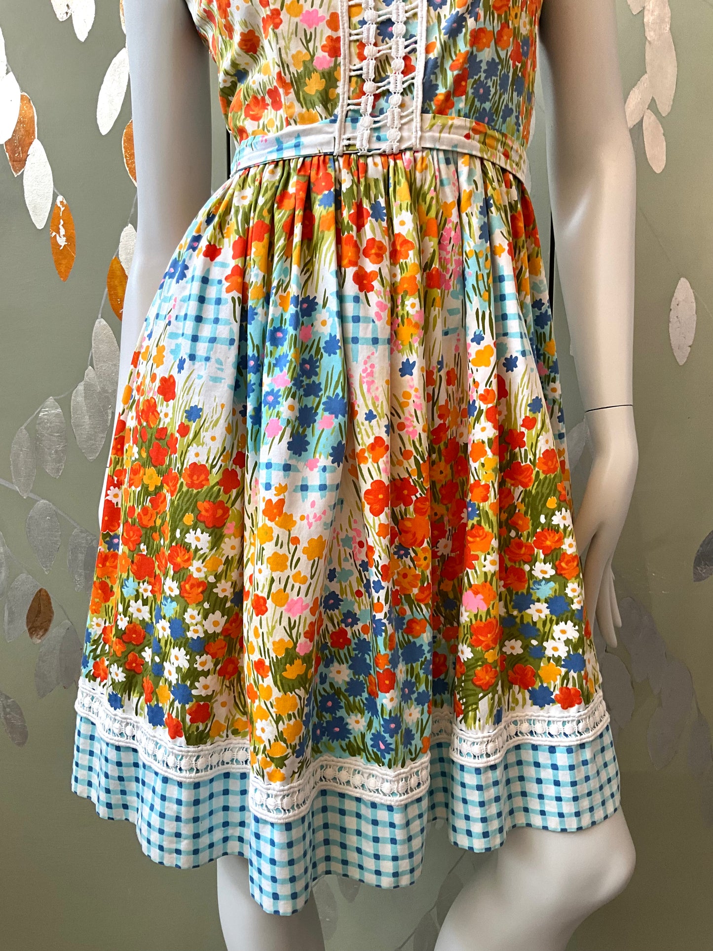 Colorful floral dress on a mannequin against a neutral background