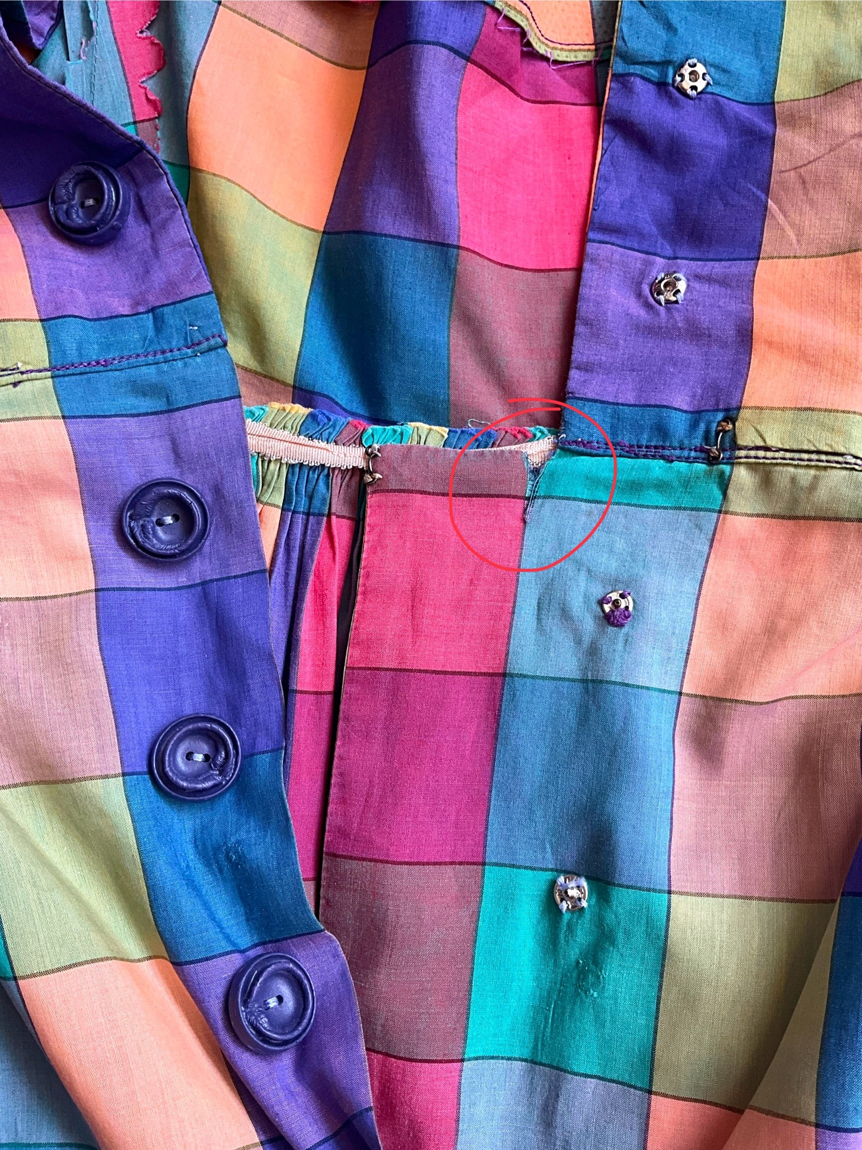 Close-up of a colorful checkered fabric with buttons