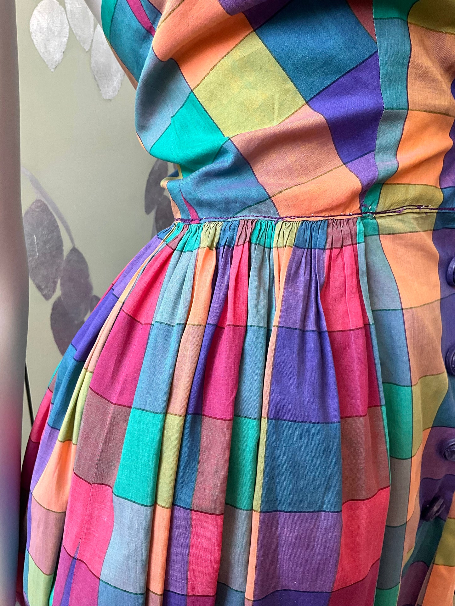 Colorful checkered dress with a pattern of multicolored squares.