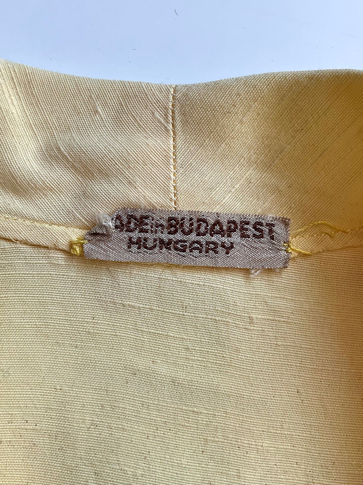 Textile label on fabric with 'Made in Budapest, Hungary' printed on it.