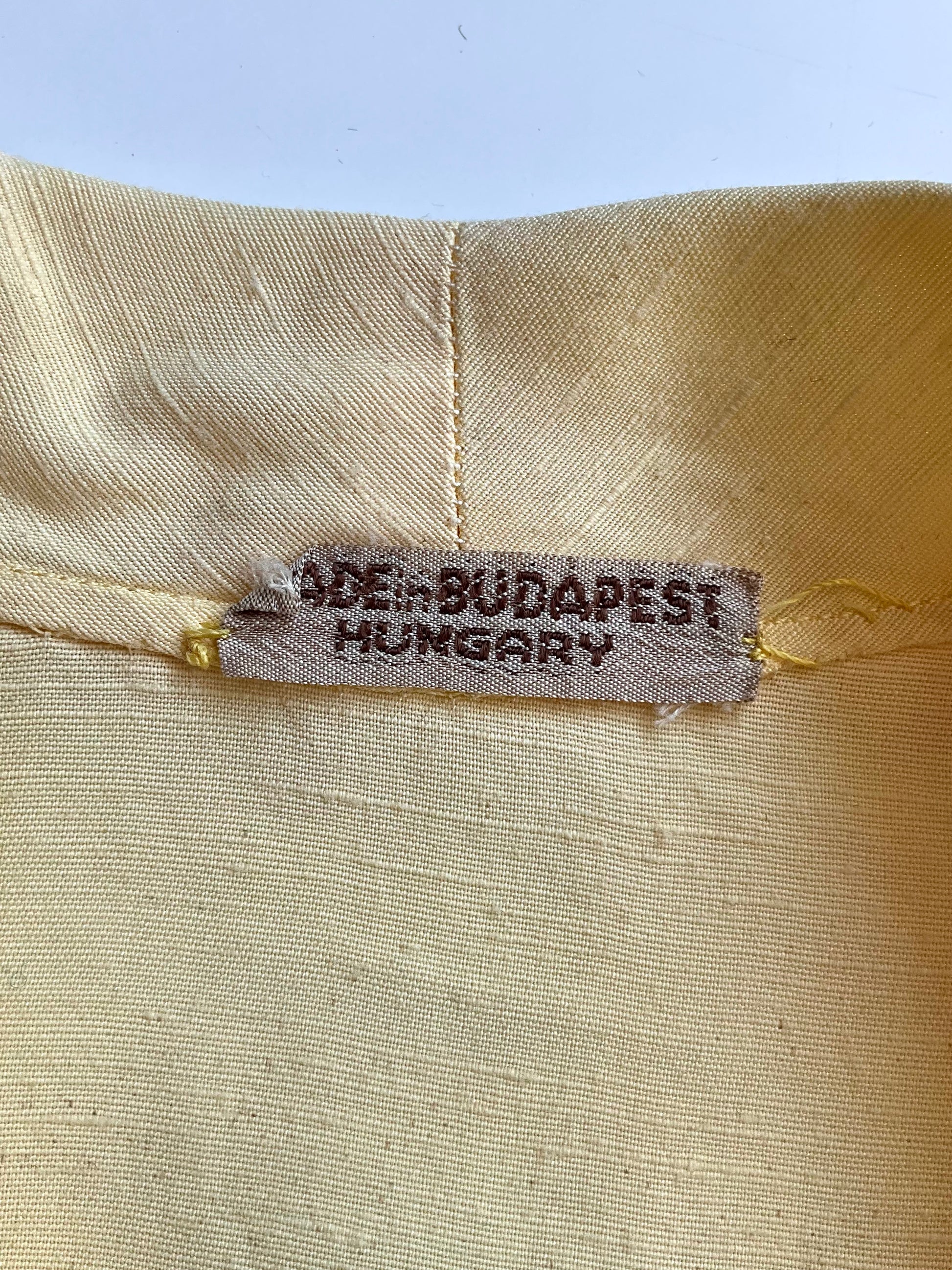 Textile label on fabric with 'Made in Budapest, Hungary' printed on it.