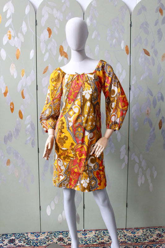 1960s orange and brown paisley print mini dress with puffy long sleeves, can be worn off the shoulder. 