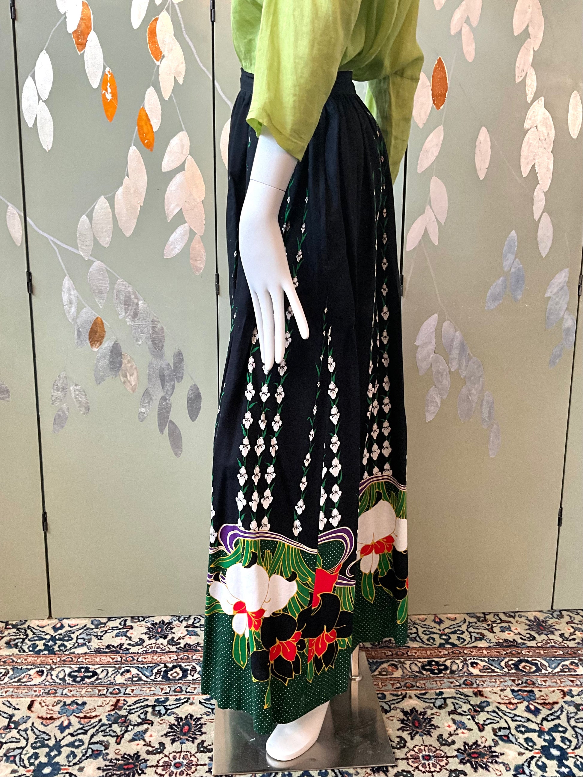 Mannequin wearing a floral pattern skirt against a decorative background