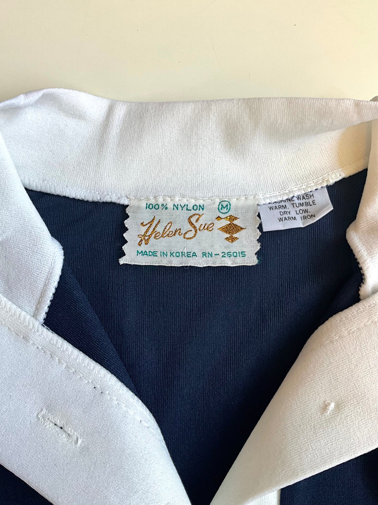 Label on a garment with 'Helen Sue' branding and text.