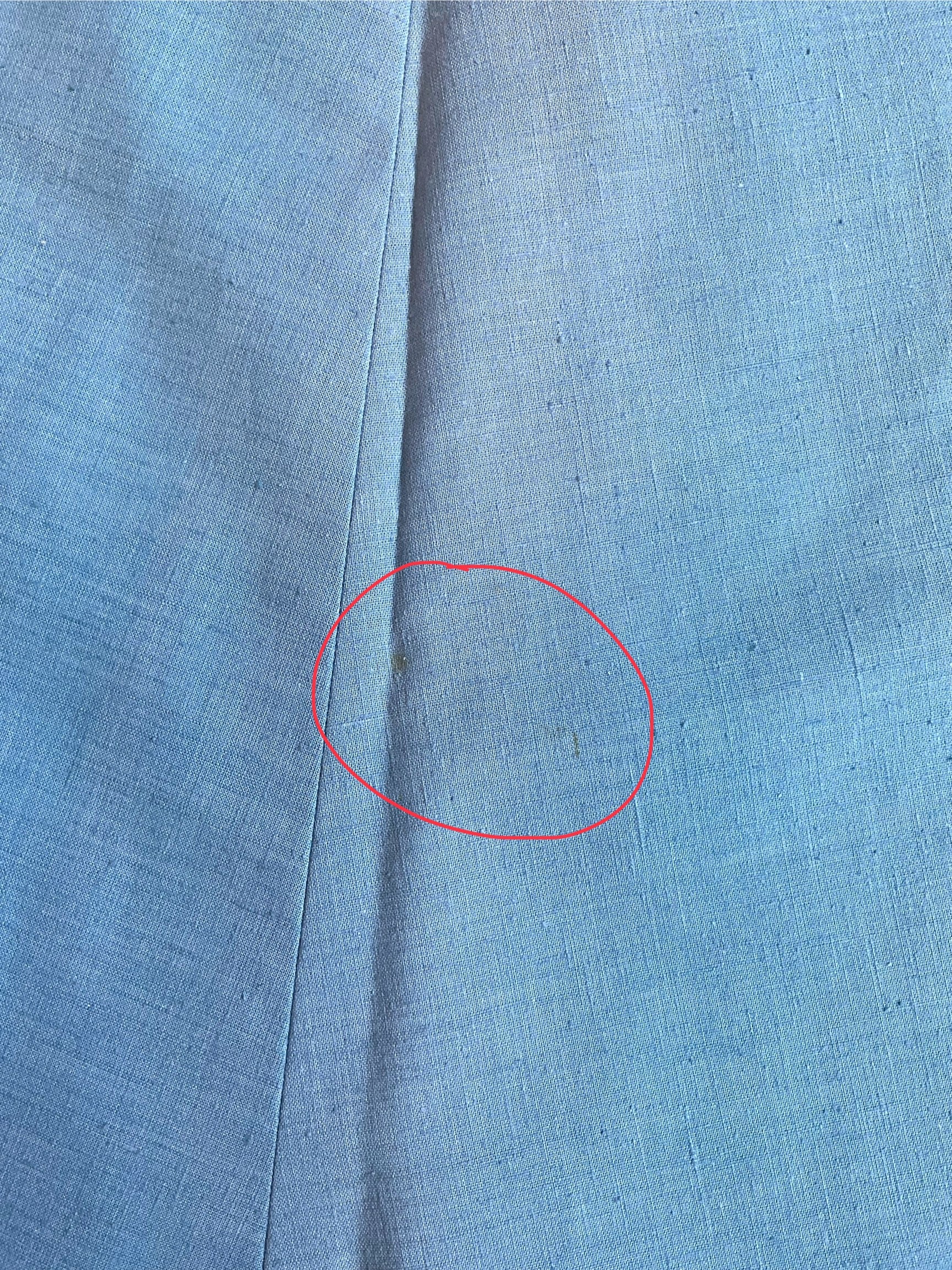 Close-up of blue fabric with a red circle highlighting a spot.