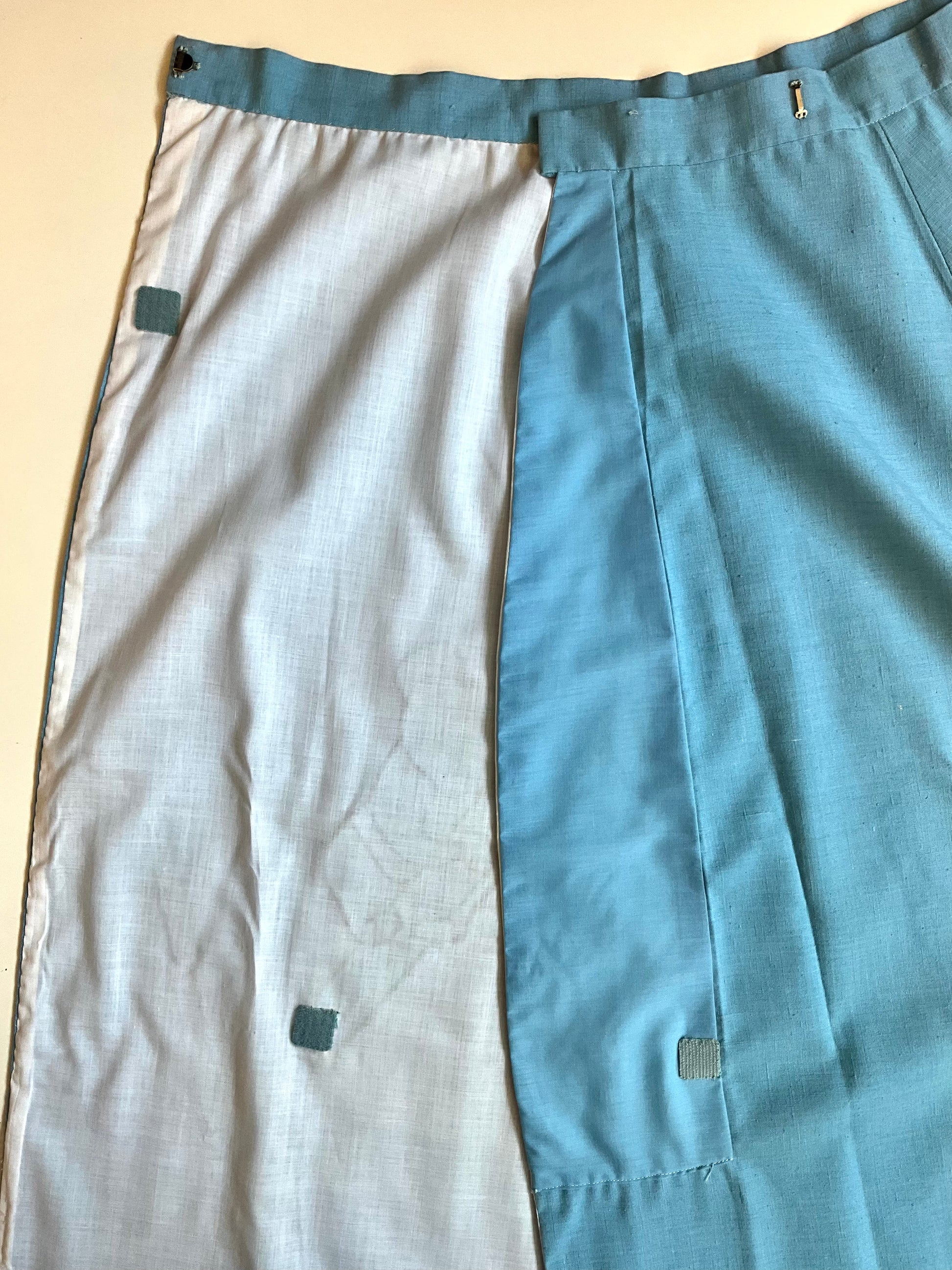 A blue skirt laid flat on a white surface.