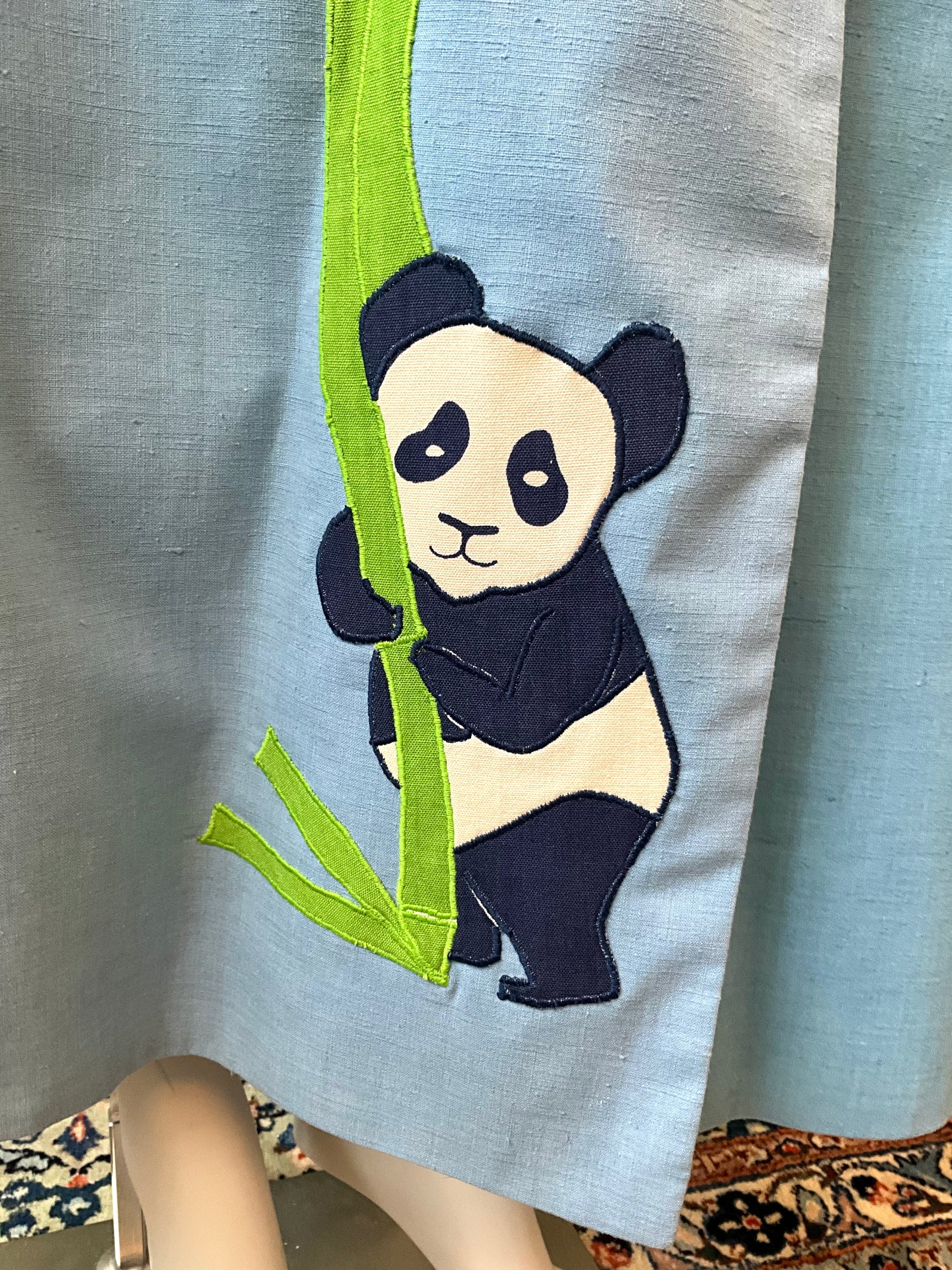 Panda bear design on a light blue fabric with green bamboo