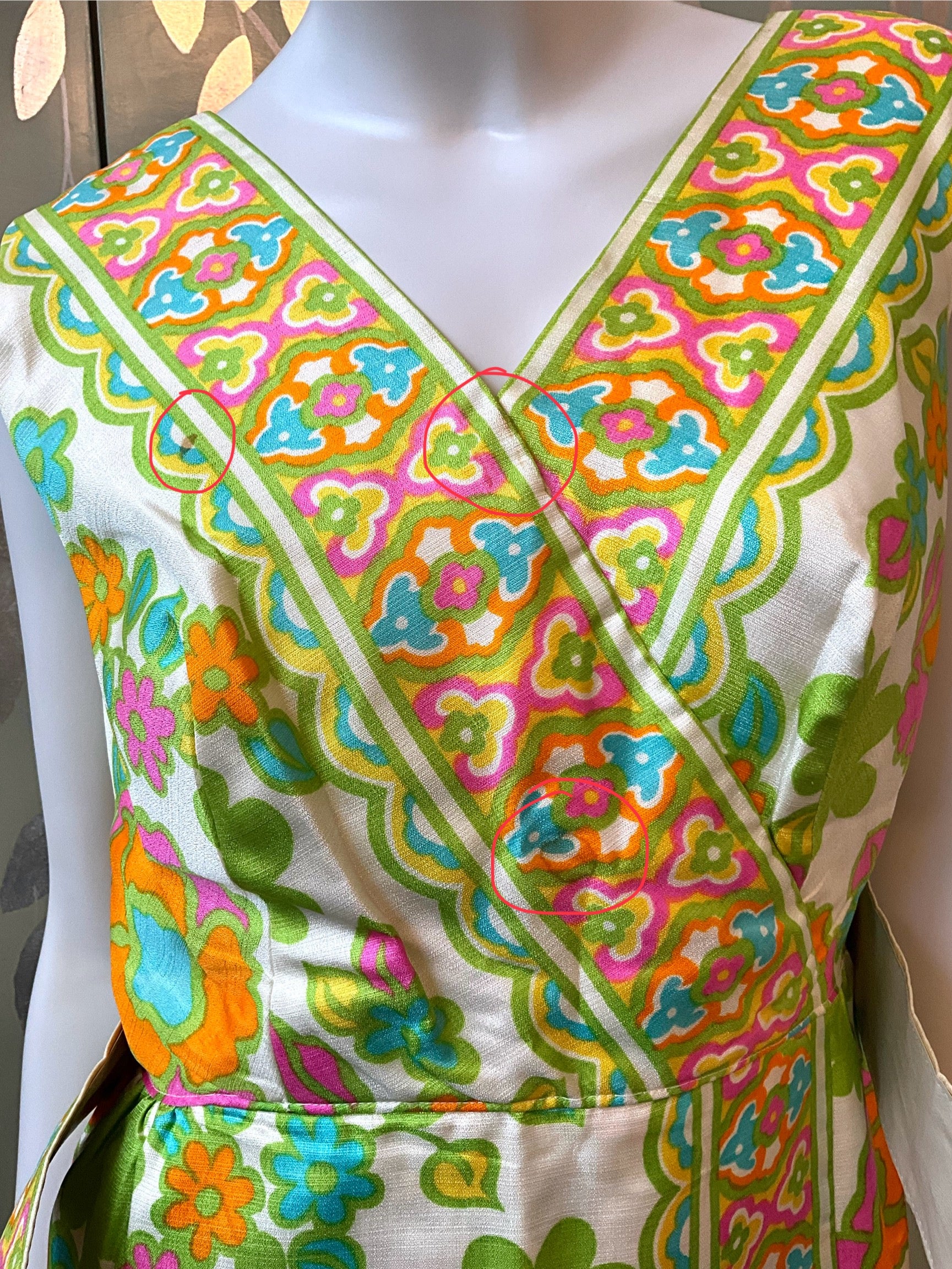 Colorful patterned dress on a mannequin with a white background