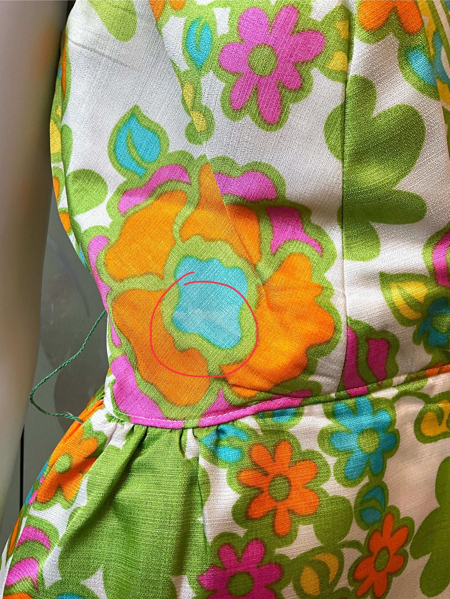 Colorful floral patterned fabric with orange, green, pink, and blue colors.