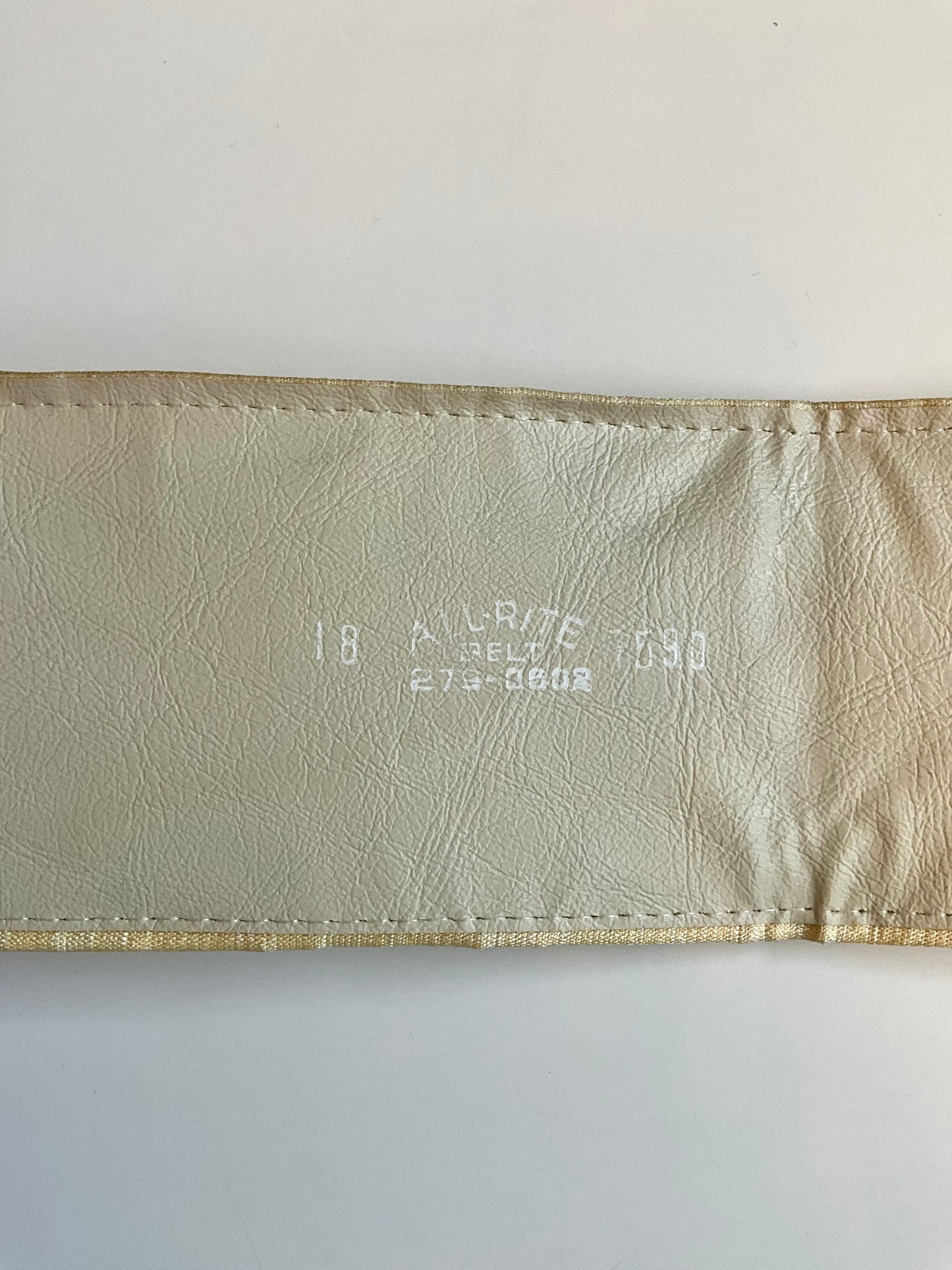 Beige leather belt with text on a white background