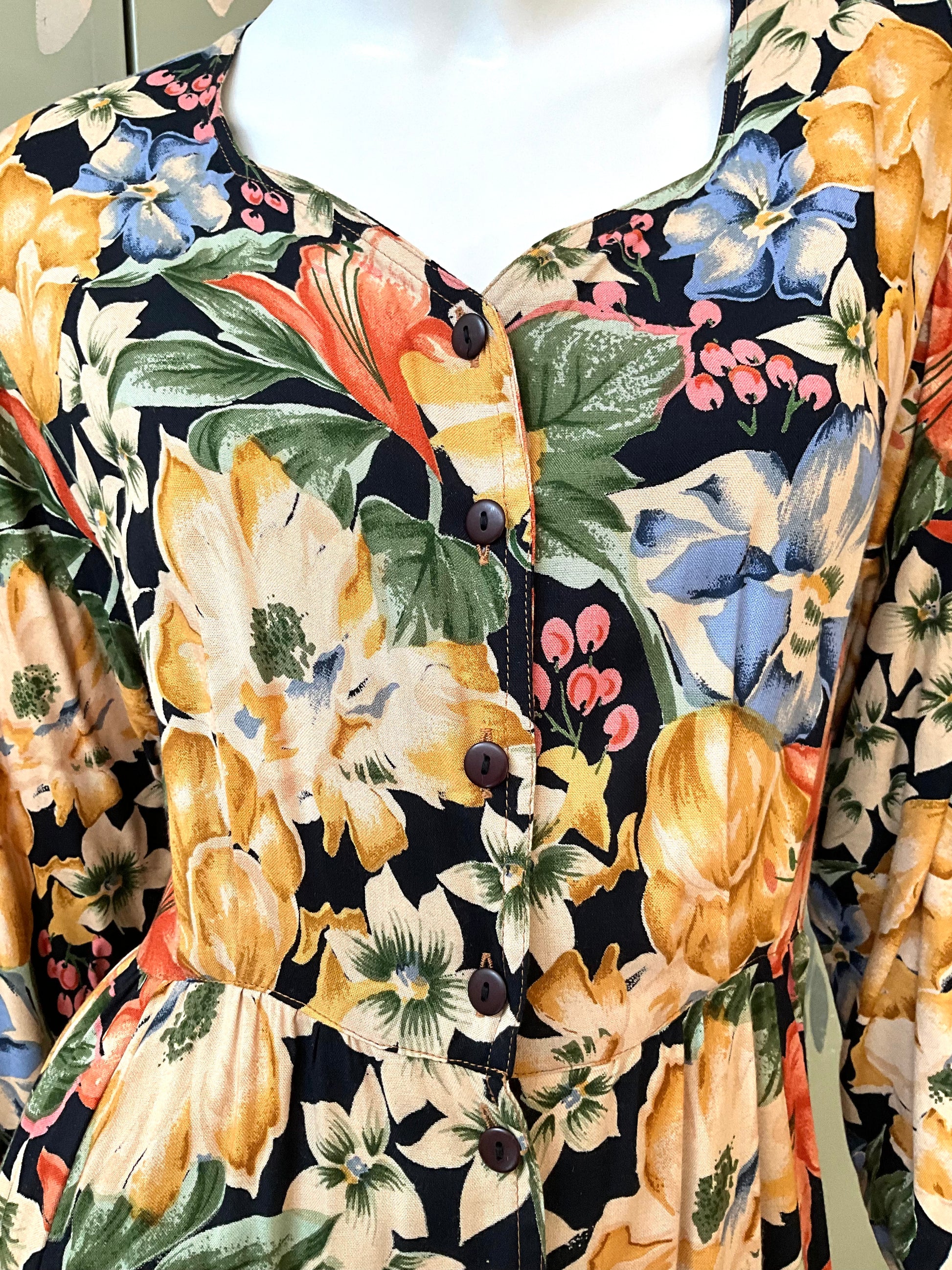 Close-up of a floral patterned dress with vibrant colors on a black background