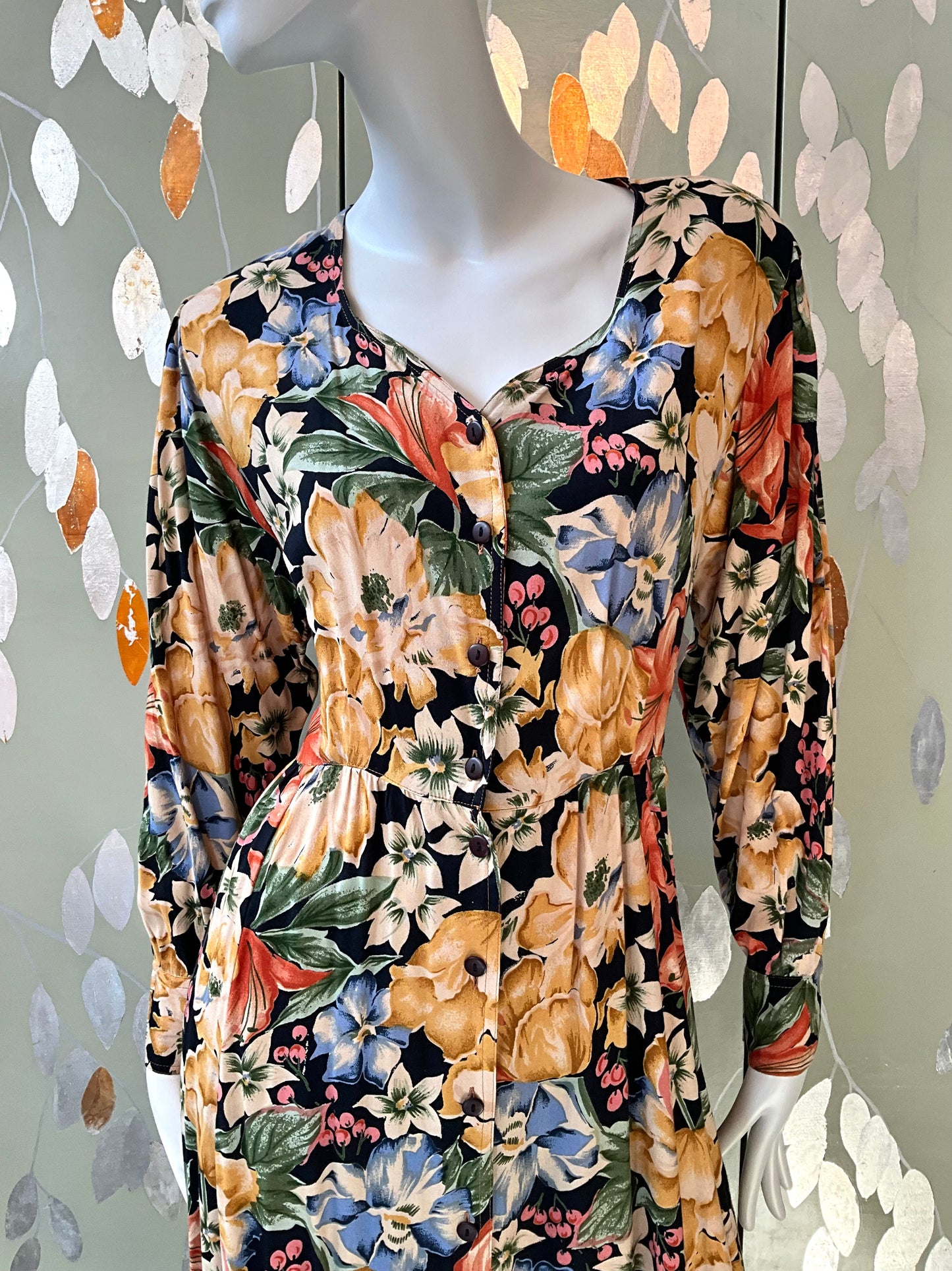 Mannequin wearing a floral dress with a black background
