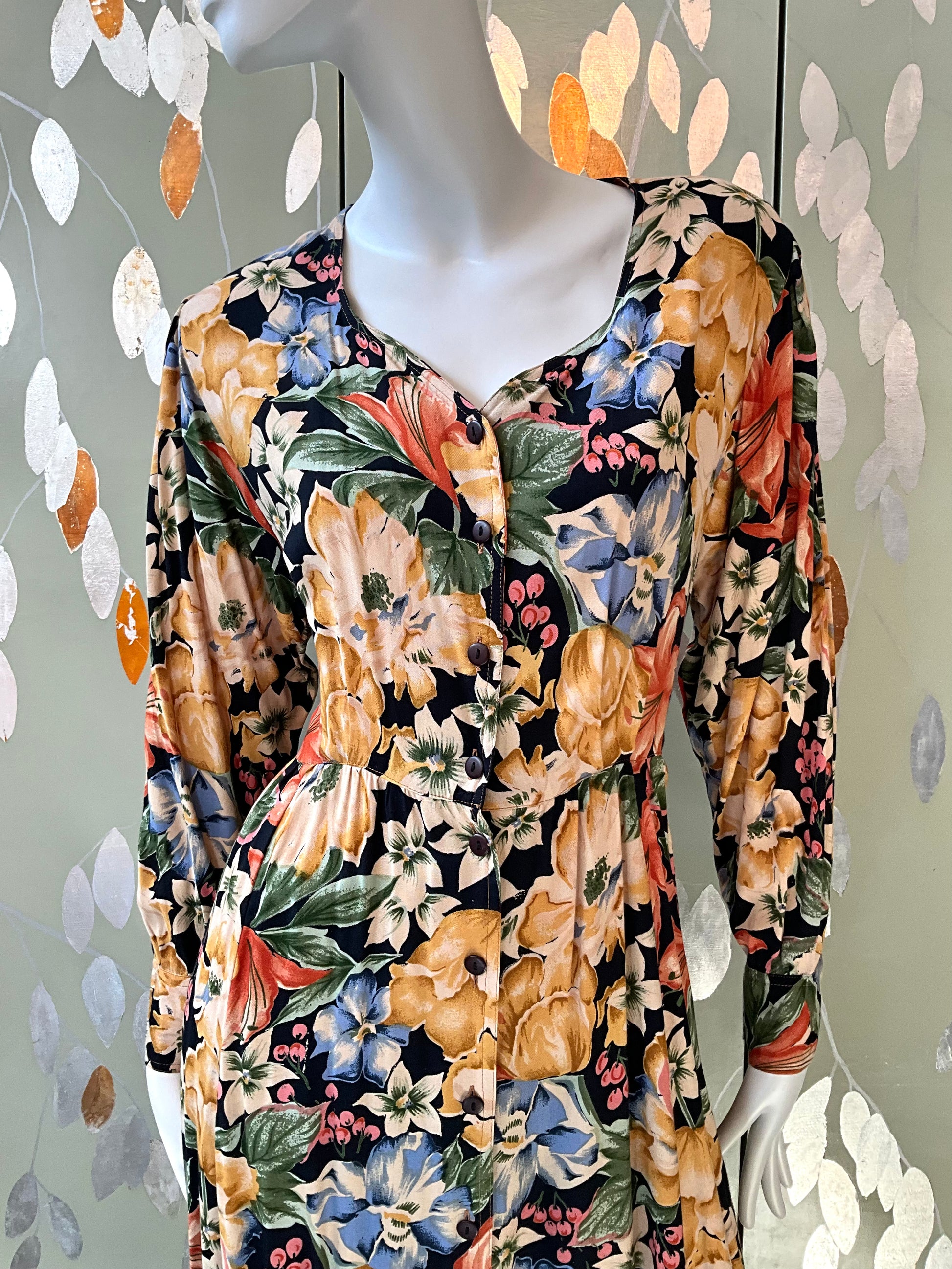 Mannequin wearing a floral dress with a black background