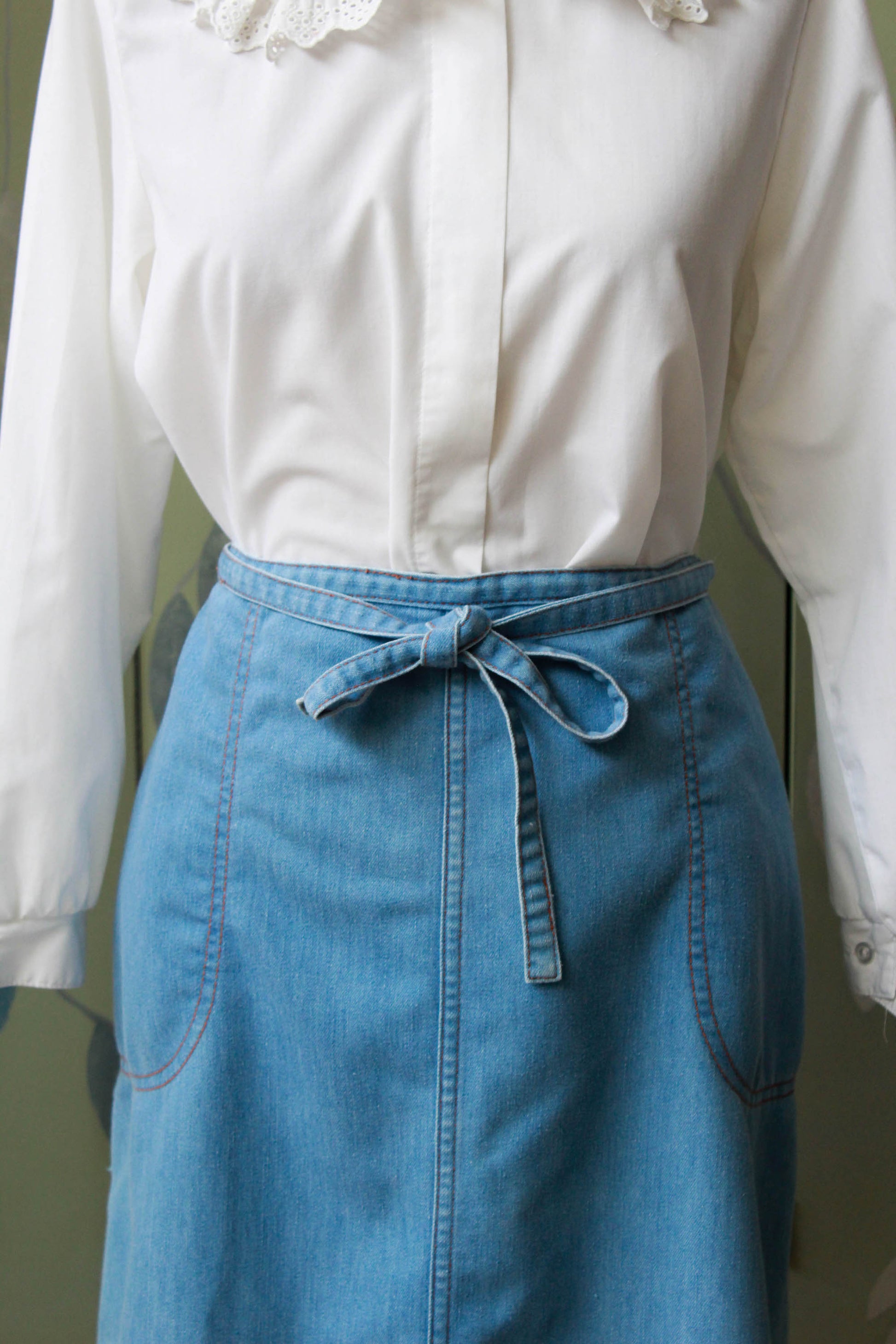 90s vintage chambray light blue jean wrap skirt with waist tie, side pockets, a-line silhouette