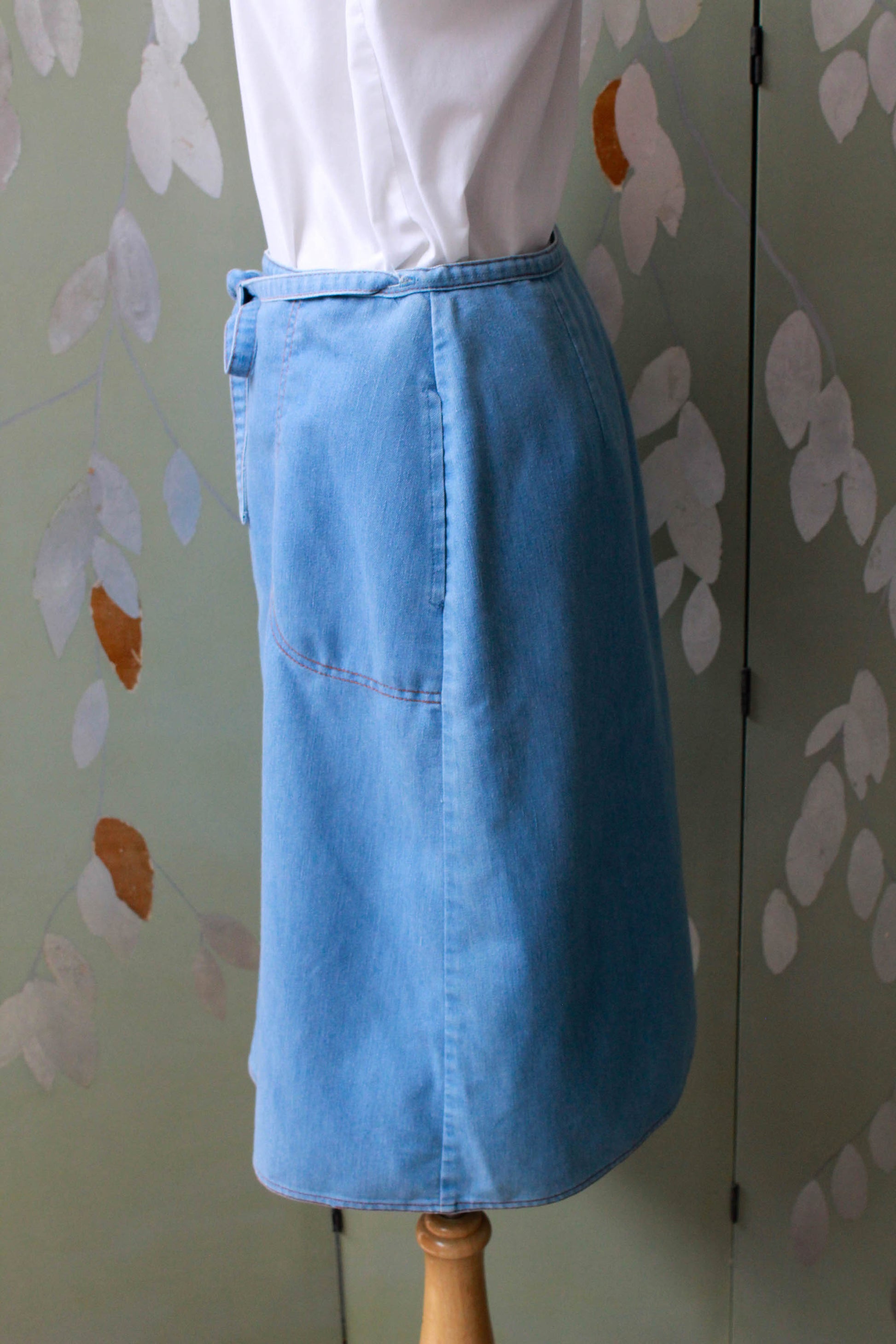 90s vintage chambray light blue jean wrap skirt with waist tie, side pockets, a-line silhouette